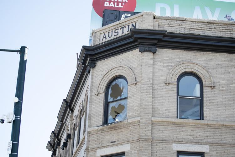 A window in the Austin apartment building on Colfax Ave. is broken out
