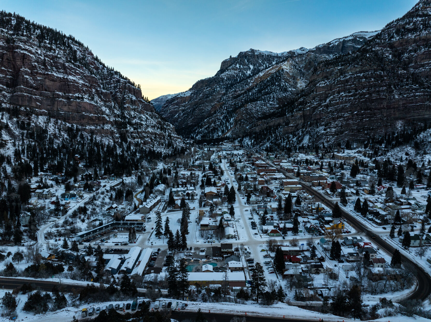 The sun rises on the town of Ouray on Friday, Jan. 24. The establishment of the Ouray Ice Park has transformed the winter economy from a once sleepy, quiet place to a bustling international winter destination. In recent years, Ouray Ice Park, Inc. has estimated 20,000 climber days a season, which might last three months. A study found the ice park generated $17.8 million in spending during the 2021-'22 season. (Parker Seibold, The Gazette) (Parker Seibold)