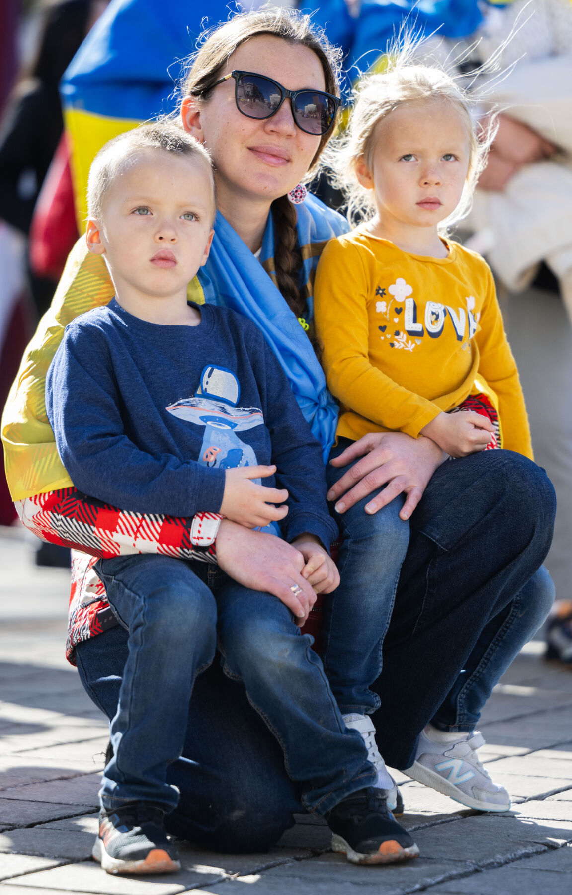 Maria Lapidus hold her 4-year-old twins, Max and Emiey, as they listen to speakers on the step of the Colorado State Capitol Sunday, Feb. 23, 2025, in Denver during a Stand for Ukraine Rally on the eve of the third anniversary of Russia's attack on Ukraine. About 1,000 people attended the rally organized by Ukrainians of Colorado. Lapidus moved to the United States from Ukraine two months before the Russians invaded her homeland. (The Gazette, Christian Murdock) (Christian Murdock, The Gazette)