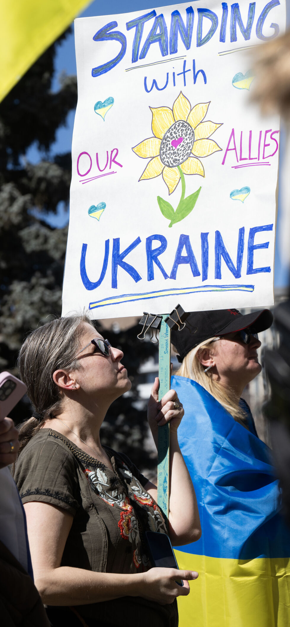 Nina Shope holds a sign in support of Ukraine during a Stand for Ukraine rally on steps of the Colorado State Capitol Sunday, Feb. 23, 2025, in Denver. The rally on the eve of the third anniversary of Russia's attack on Ukraine was organized by Ukrainians of Colorado. 
