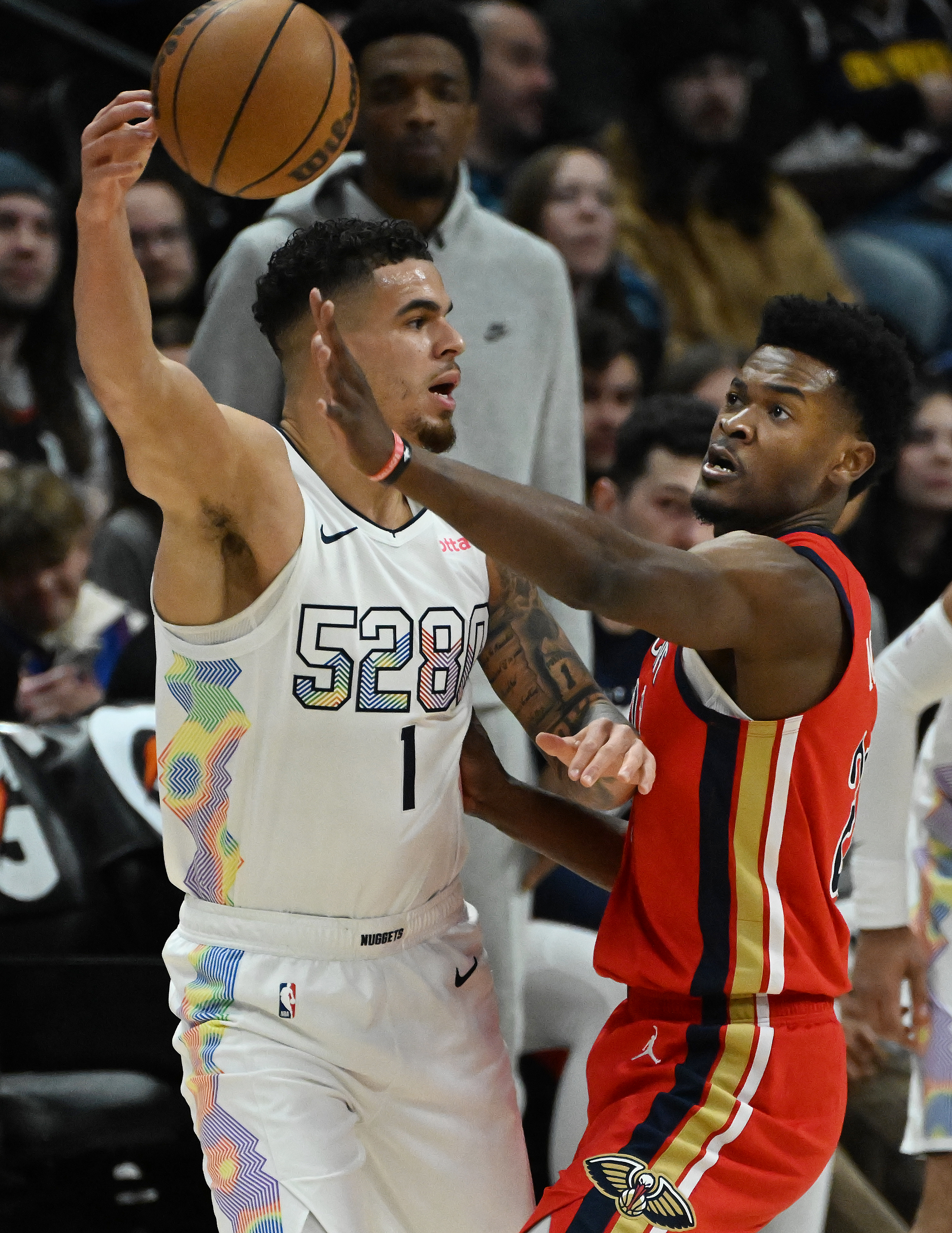 Nuggets Michael Porter, Jr. passes the ball past Pelicans Yves Missi during the first quarter of a game at Ball Arena on Wednesday, Feb. 5, 2025. (Jerilee Bennett,The Gazette)