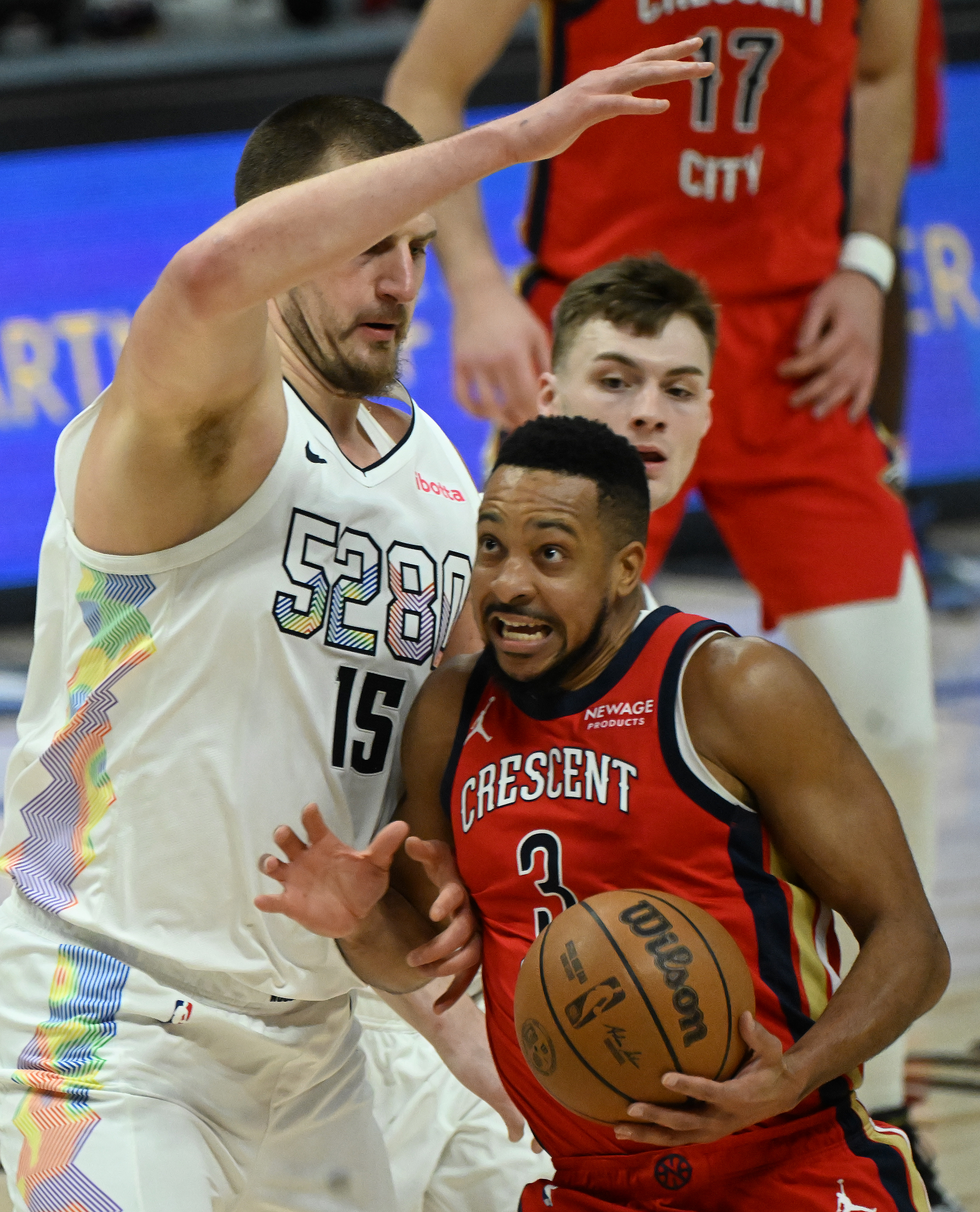 Denver Nuggets center Nikola Jokic (15) defends Pelicans CJ McCollum during a game at Ball Arena on Wednesday, Feb. 5, 2025. The Nuggets defeated the Pelicans 144-119. (Jerilee Bennett,The Gazette)