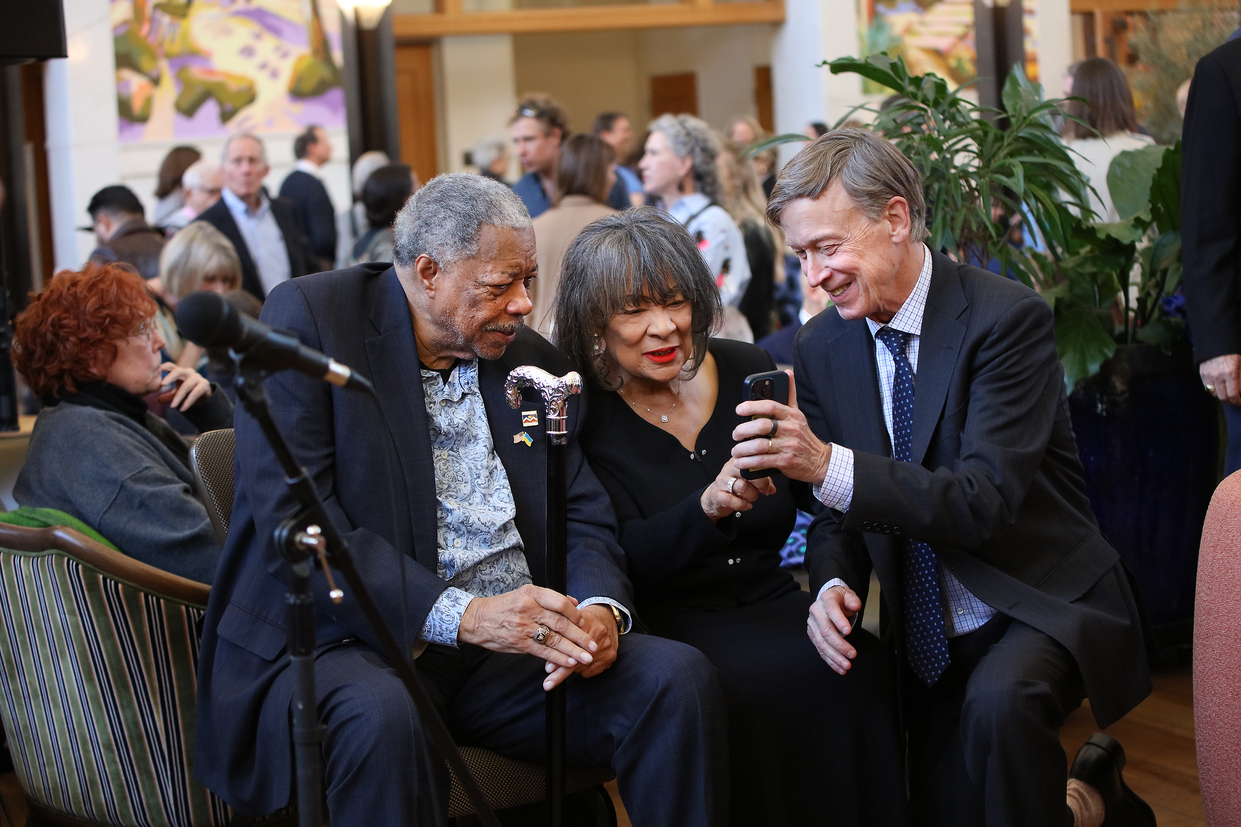 Foamier Denver Mayor Wellinton Webb, left, his wife Wilma Webb, center and Senator John Hickenlooper (D-CO) connect during the memorial service for Dana Crawford at Union Station in Downtown Denver, Colo., Sunday . Feb. 23, 2025. Crawford is considered to be one of the most influential preservationist and developers in Downtown Denver city’s history. (Photo by Bear Gutierrez) (Bear Gutierrez)