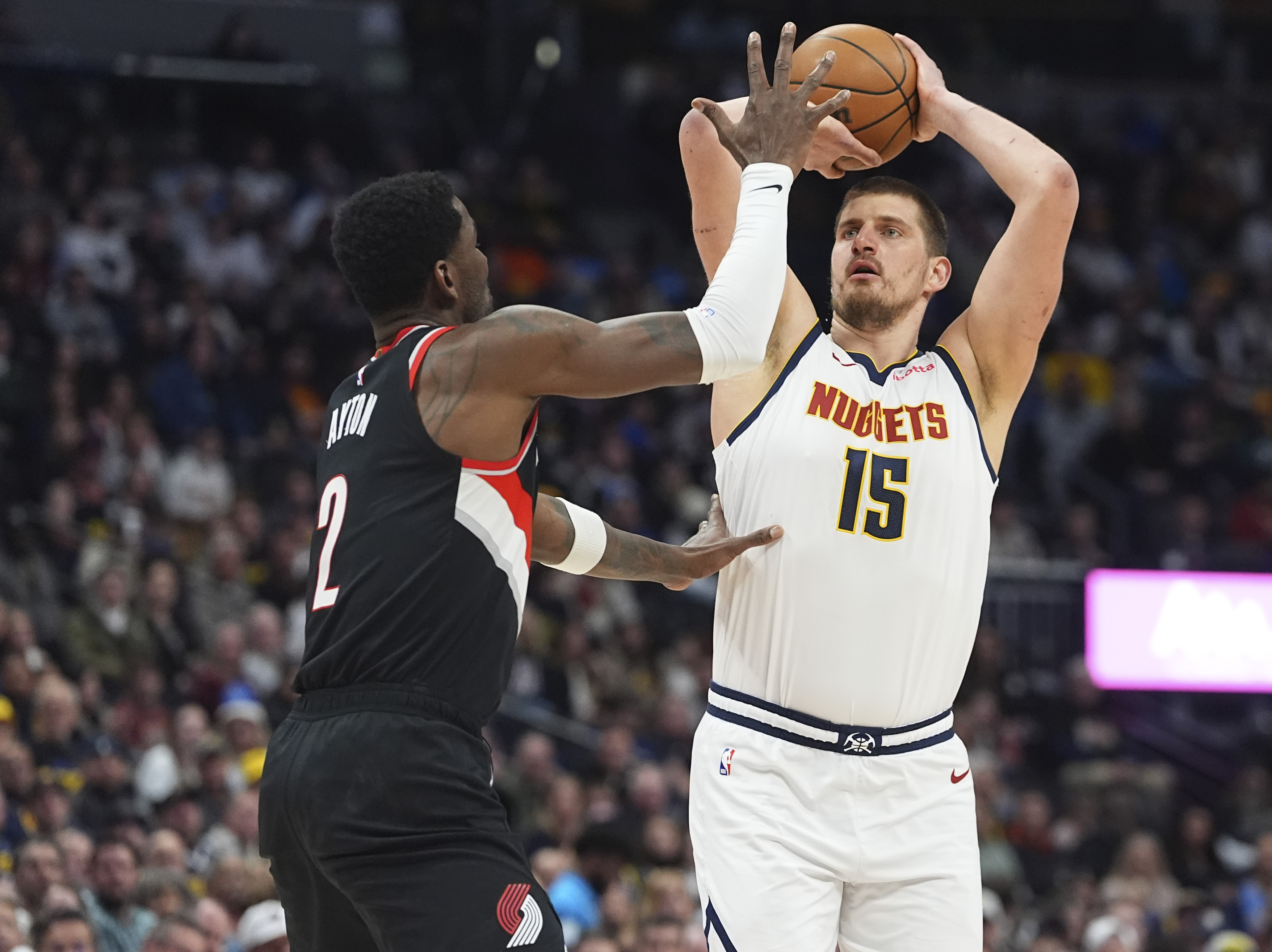 Denver Nuggets center Nikola Jokic, right, looks to shoot for a basket over Portland Trail Blazers center Deandre Ayton, left, in the first half of an NBA basketball game Monday, Feb. 10, 2025, in Denver. (AP Photo/David Zalubowski) (David Zalubowski)