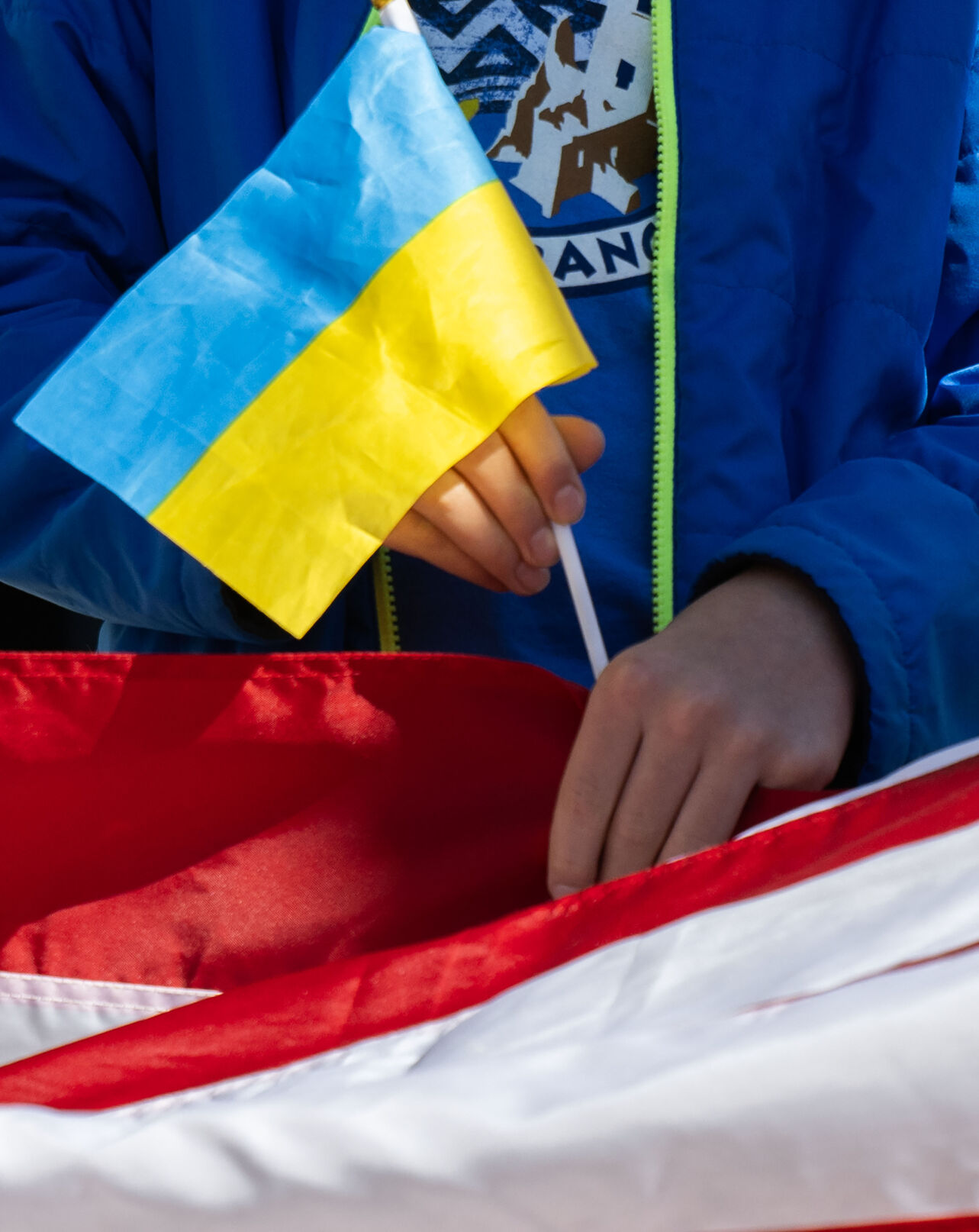 A child holds an Ukrainian flag in one hand while holding a United States flag in the other one during a Stand for Ukraine rally on steps of the Colorado State Capitol Sunday, Feb. 23, 2025, in Denver. The rally on the eve of the third anniversary of Russia's attack on Ukraine was organized by Ukrainians of Colorado. (The Gazette, Christian Murdock) (Christian Murdock, The Gazette)