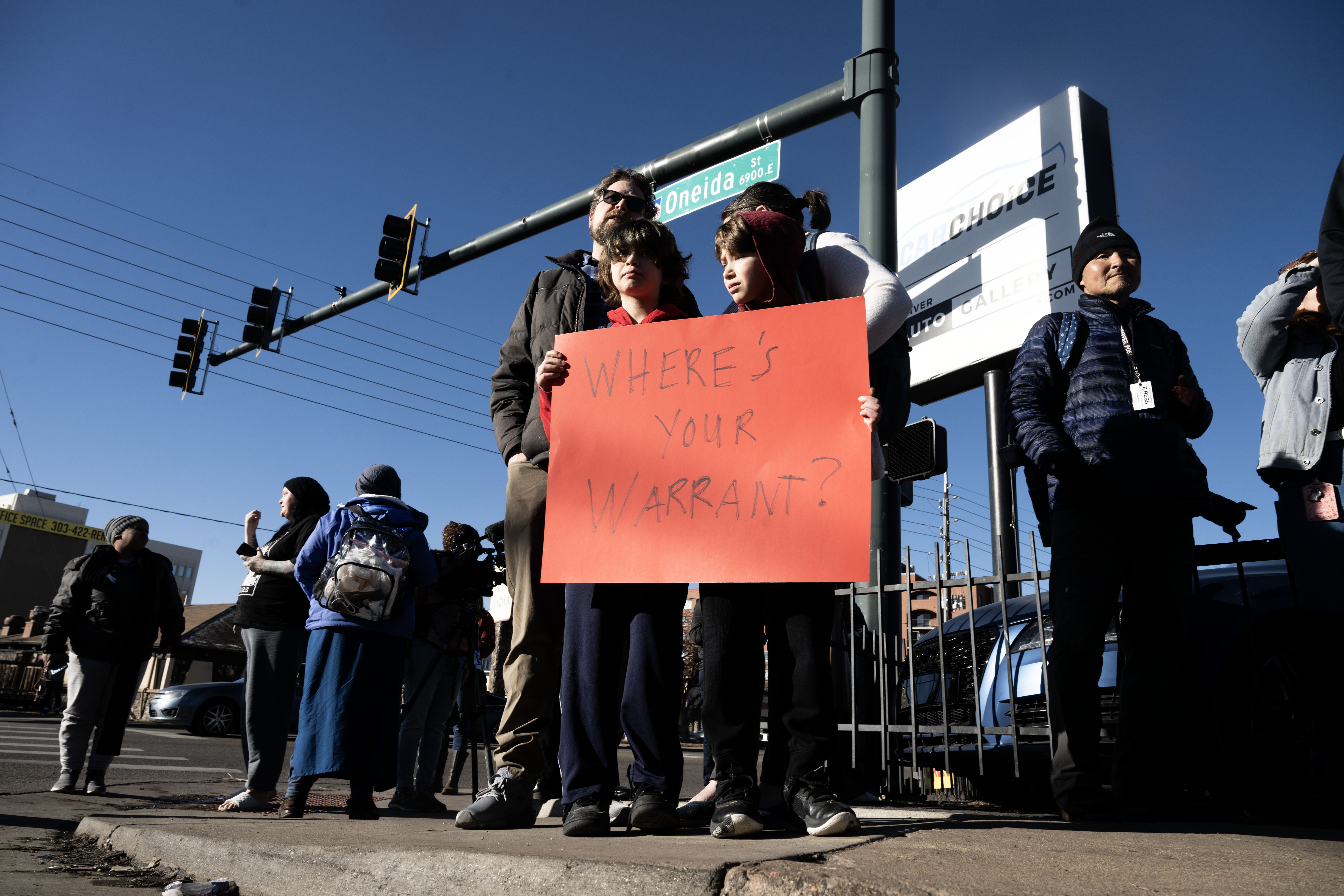 Protesters hold signs and chant slogans across the street from Cedar Run Apartments in Denver as Drug Enforcement Agency agents execute a warrant on Wednesday, Feb. 5, 2025. (Stephen Swofford, Denver Gazette) (StephenSwoffordPhotographerstephen.swofford@gazette.comhttps://secure.gravatar.com/avatar/1ddcaf11c5d70eaa58546ddc4e038687?d=mm&r=g)