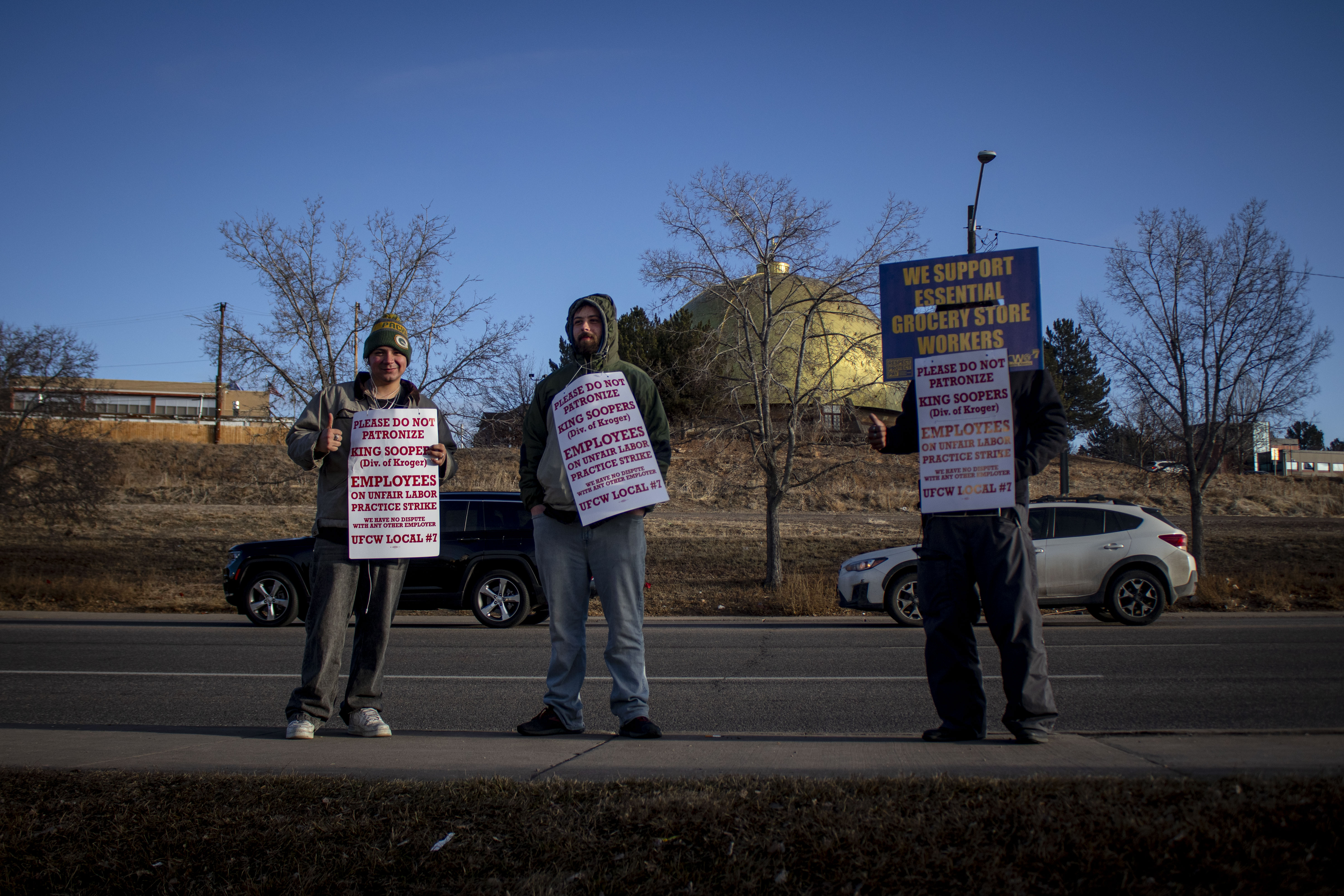 King Soopers workers Julian, Chase and Xander protest outside a store in Glendale, Colo. on Feb. 6, 2025. (Bernadette Berdychowski / The Denver Gazette)