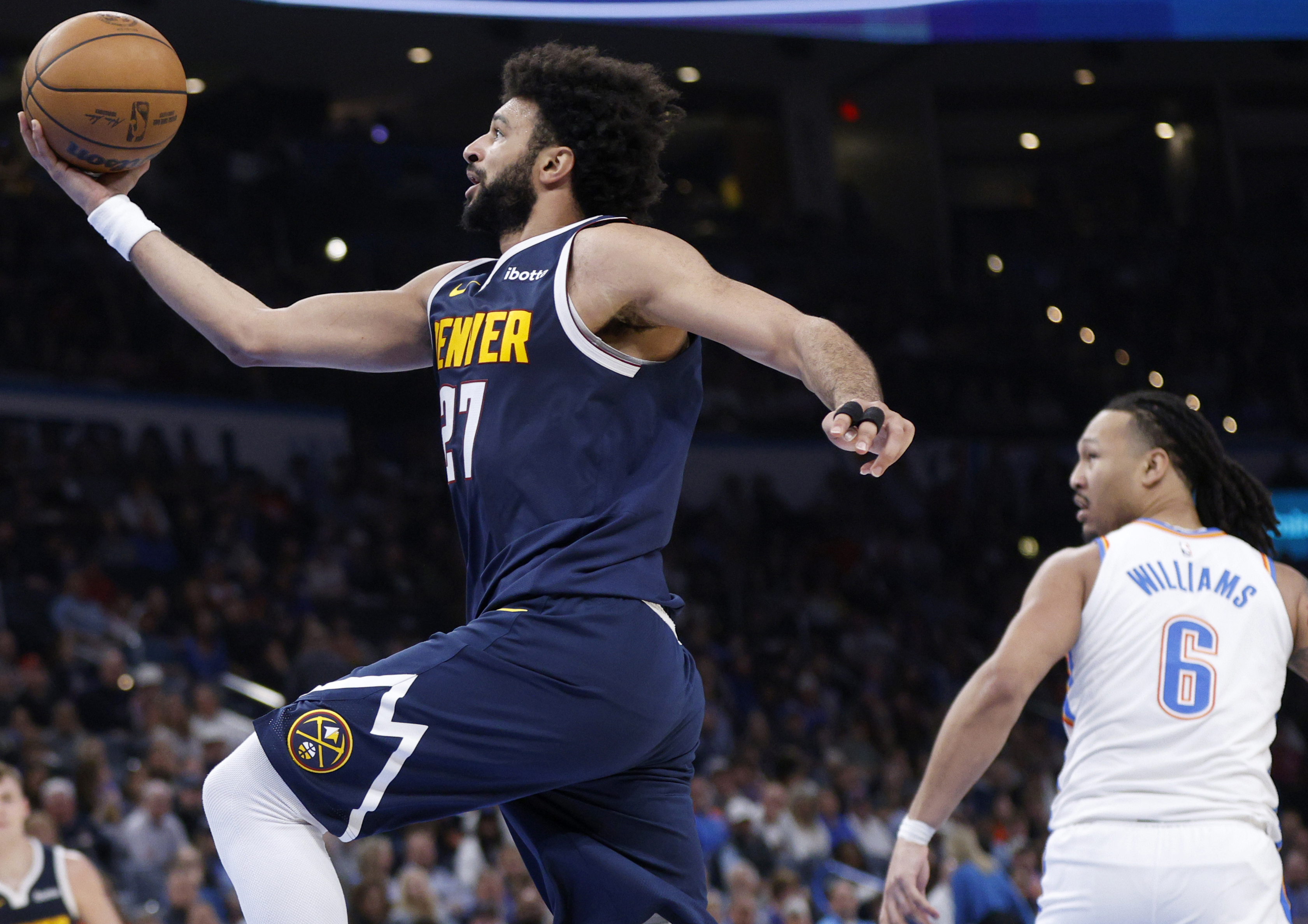 Denver Nuggets guard Jamal Murray, left, takes the ball to the basket as Oklahoma City Thunder forward Jaylin Williams (6) watches during the second half of an NBA basketball game Monday, March 10, 2025, in Oklahoma City. (AP Photo/Nate Billings) (Nate Billings)