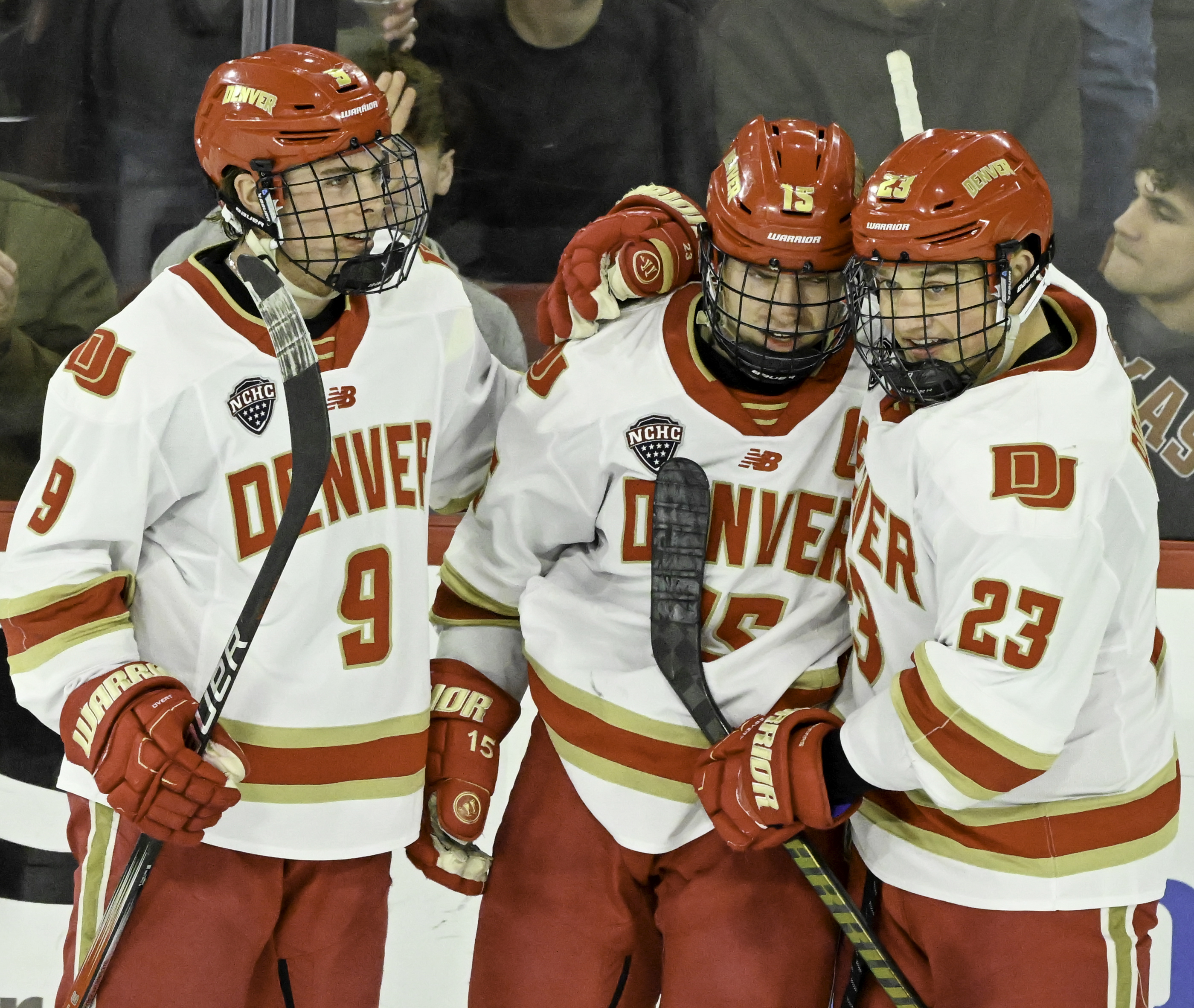 DU’s Boston Buckberger and Eric Pohlkamp hug Carter King after King scored one of his two goals against CC at Magness Arena on Sunday, March 16, 2025. (Jerilee Bennett)