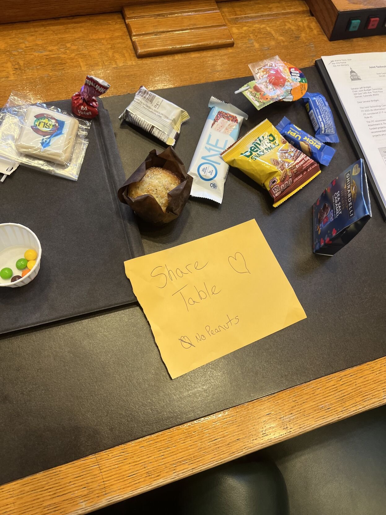 The desk of Rep. Ron Weinberg of Loveland is now the snack stand, apparently, for the House. Photo courtesy Rep. Jarvis Caldwell of Monument, who claims he had nothing to do with it.And somebody doesn't like peanuts, apparently.