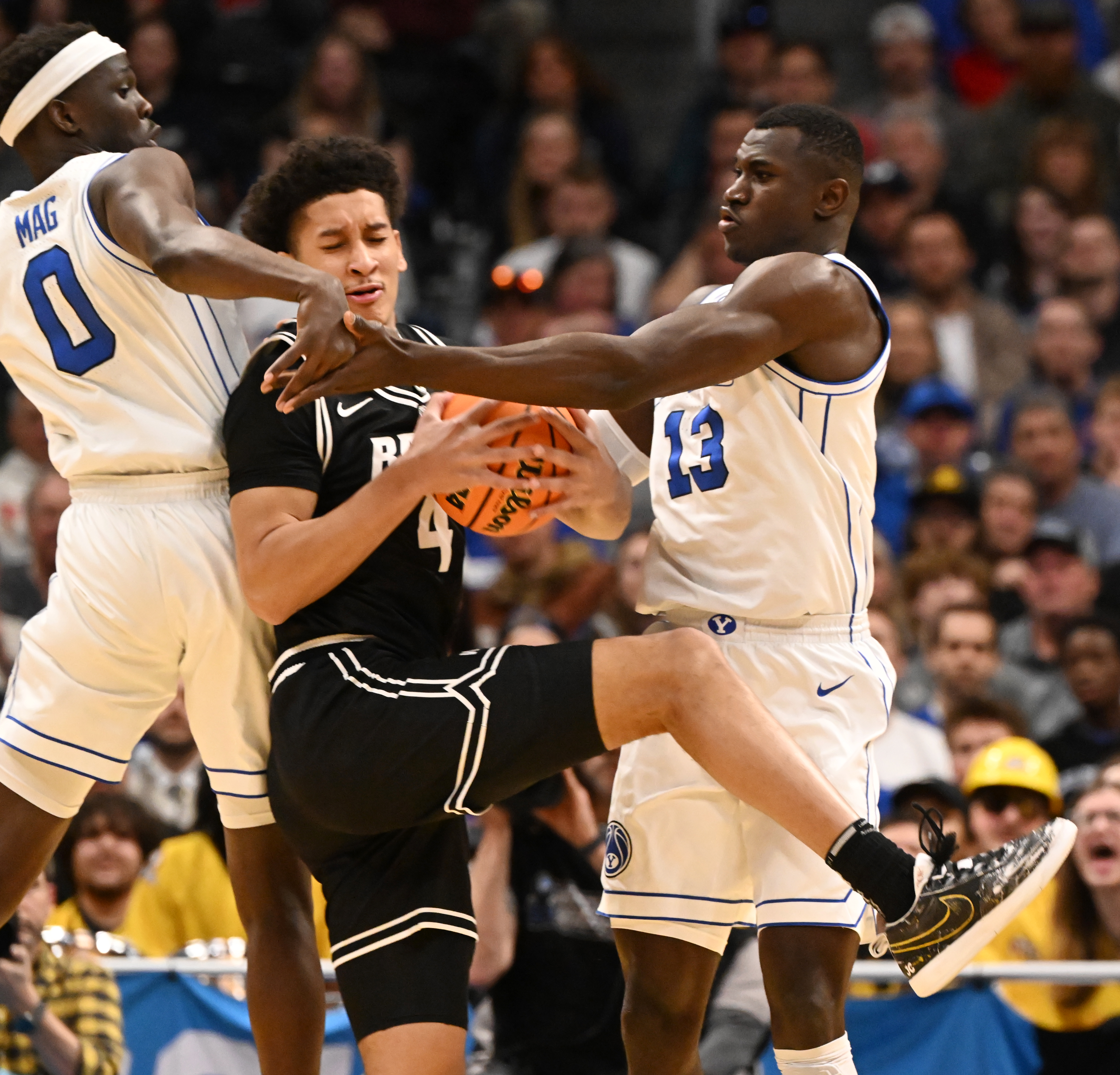 Brigham Young Cougars forward Mawot Mag (0) and Brigham Young Cougars center Keba Keita (13) fight for the ball with Virginia Commonwealth Rams forward Jack Clark (4) during the second half of a round 1 game of the NCAA March Madness tournament at Ball Arena on Thursday, March 20, 2025. BYU defeated VCU 80-71. (Jerilee Bennett,The Gazette)