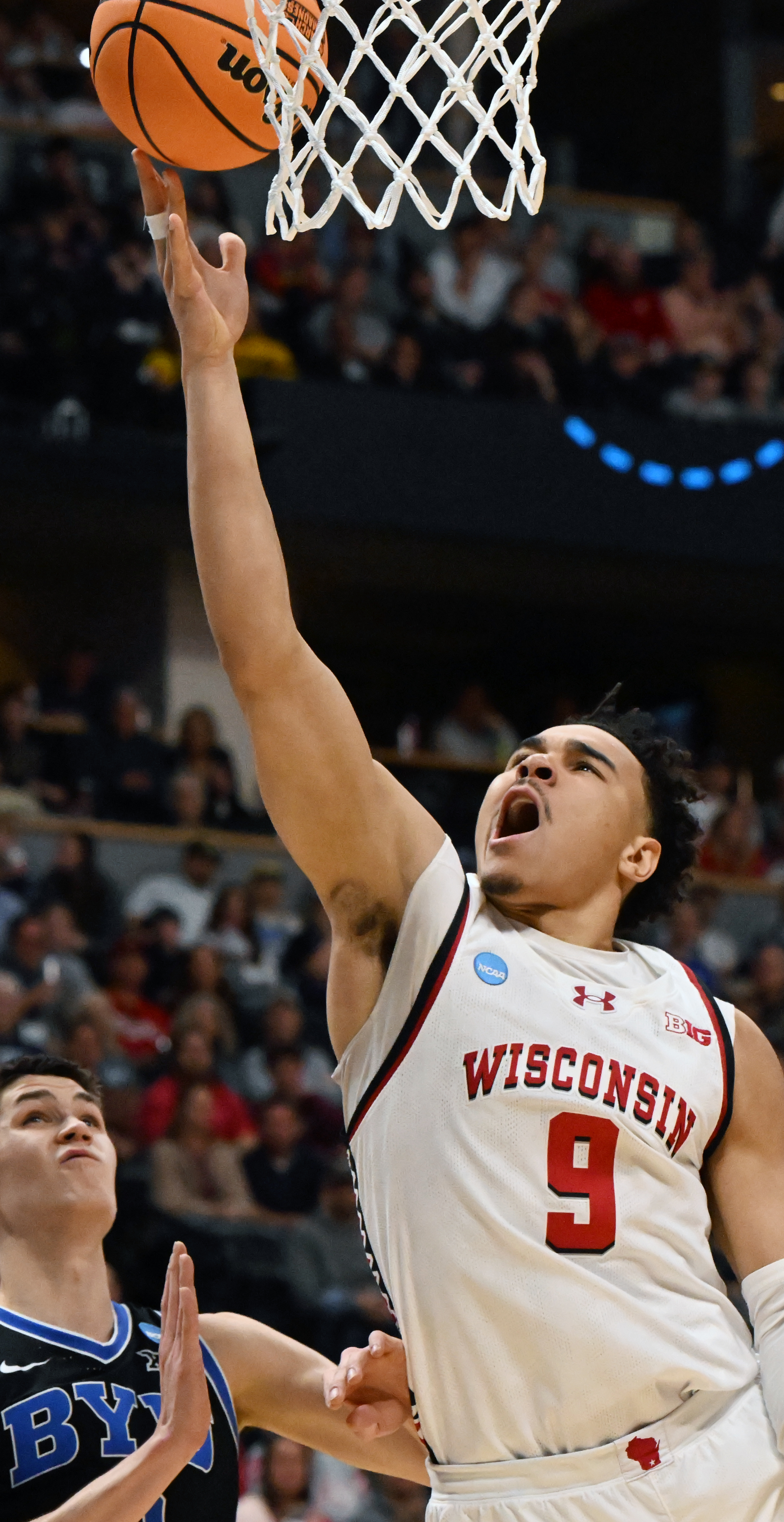 Wisconsin Badgers guard John Tonje (9) scores a basketball while being defended by Brigham Young Cougars guard Egor Demin (3) during the first half of the second round of March Madness at Ball Arena on Saturday, March 22, 2025. BYU won the game 91-89 and will be going to the Sweet Sixteen. (Jerilee Bennett,The Gazette)