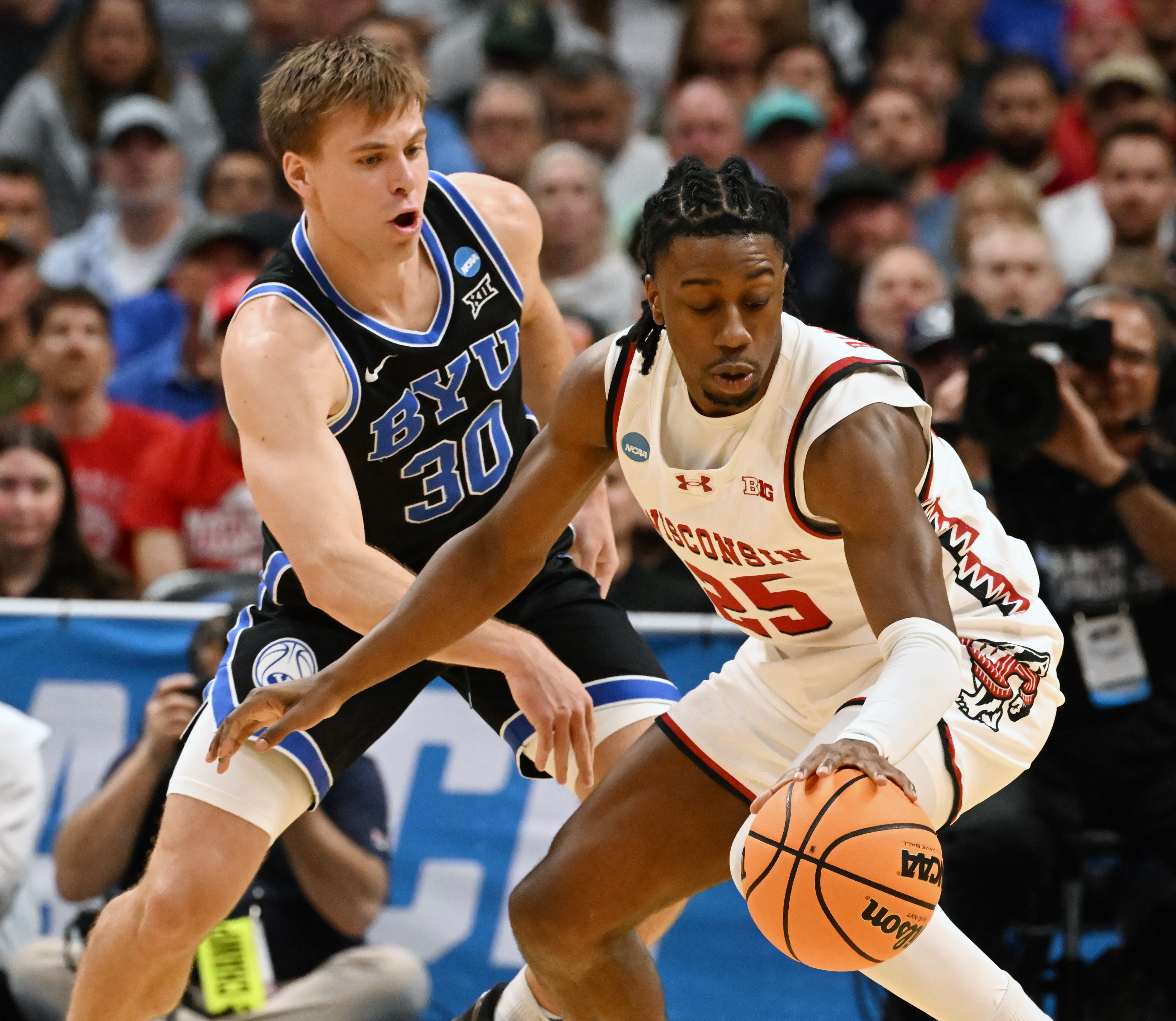 Brigham Young Cougars guard Dallin Hall (30) defends Wisconsin Badgers guard John Blackwell (25) during the second round of March Madness at Ball Arena on Saturday, March 22, 2025. BYU won the game 91-89 and will be going to the Sweet Sixteen. (Jerilee Bennett,The Gazette)