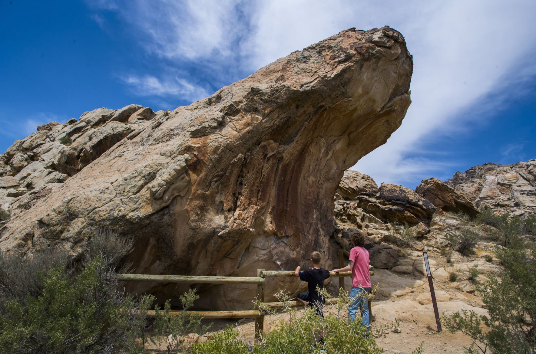Cole and Carter Bridges of Salt Lake City, Utah, look at petroglyphs Tuesday, June 4, 2018, along the Fossil Discovery Trail between the Jensen, Utah, visitor center and the Quarry Exhibit Hall in Dinosaur National Monument at the Utah/Colorado border. (The Gazette, Christian Murdock) (CHRISTIAN MURDOCK, THE GAZETTE)