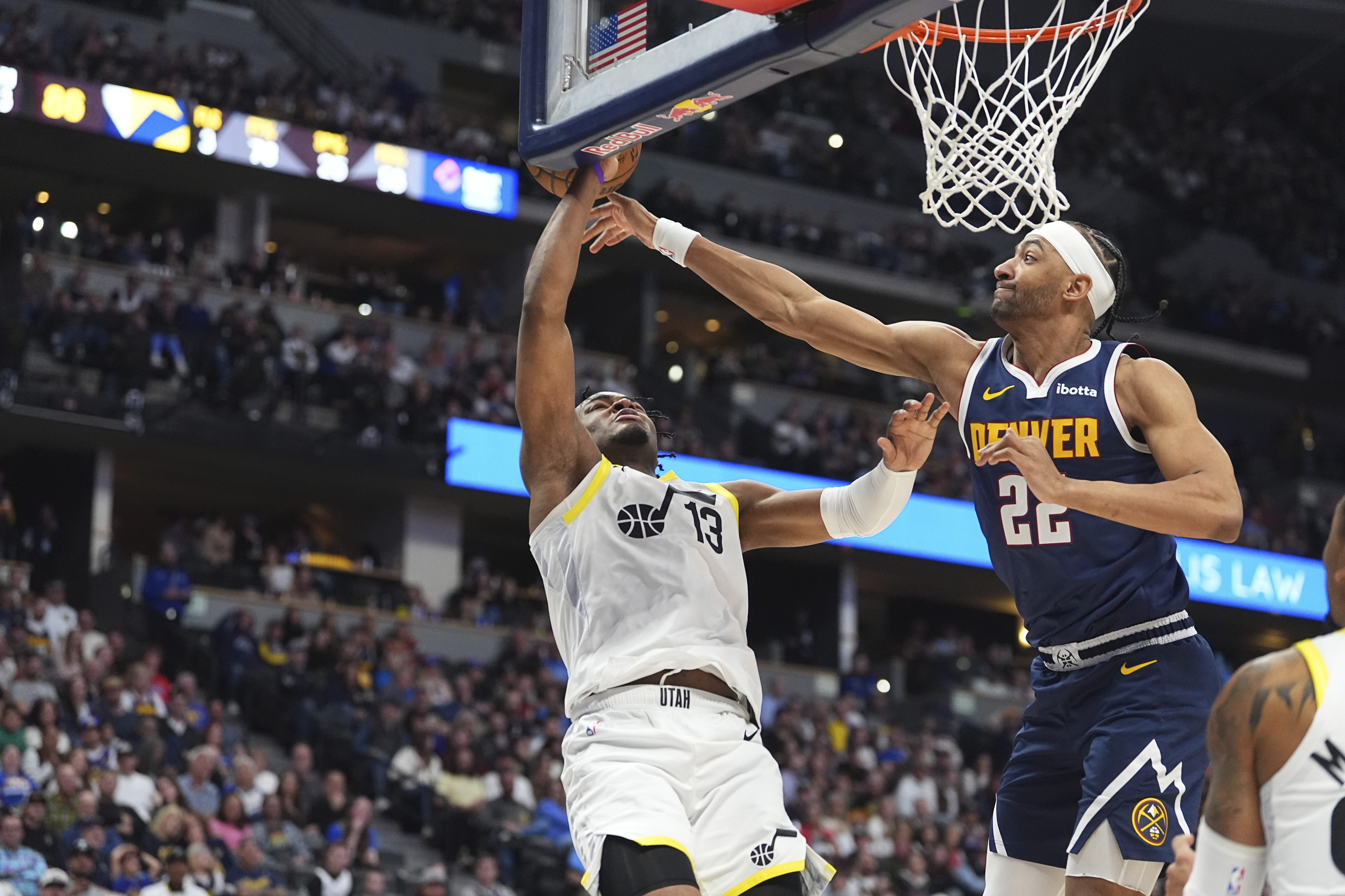 Denver Nuggets forward Zeke Nnaji (22) blocks a shot by Utah Jazz guard Isaiah Collier (13) in the second half of an NBA basketball game Friday, March 28, 2025, in Denver. (AP Photo/David Zalubowski) (David Zalubowski)