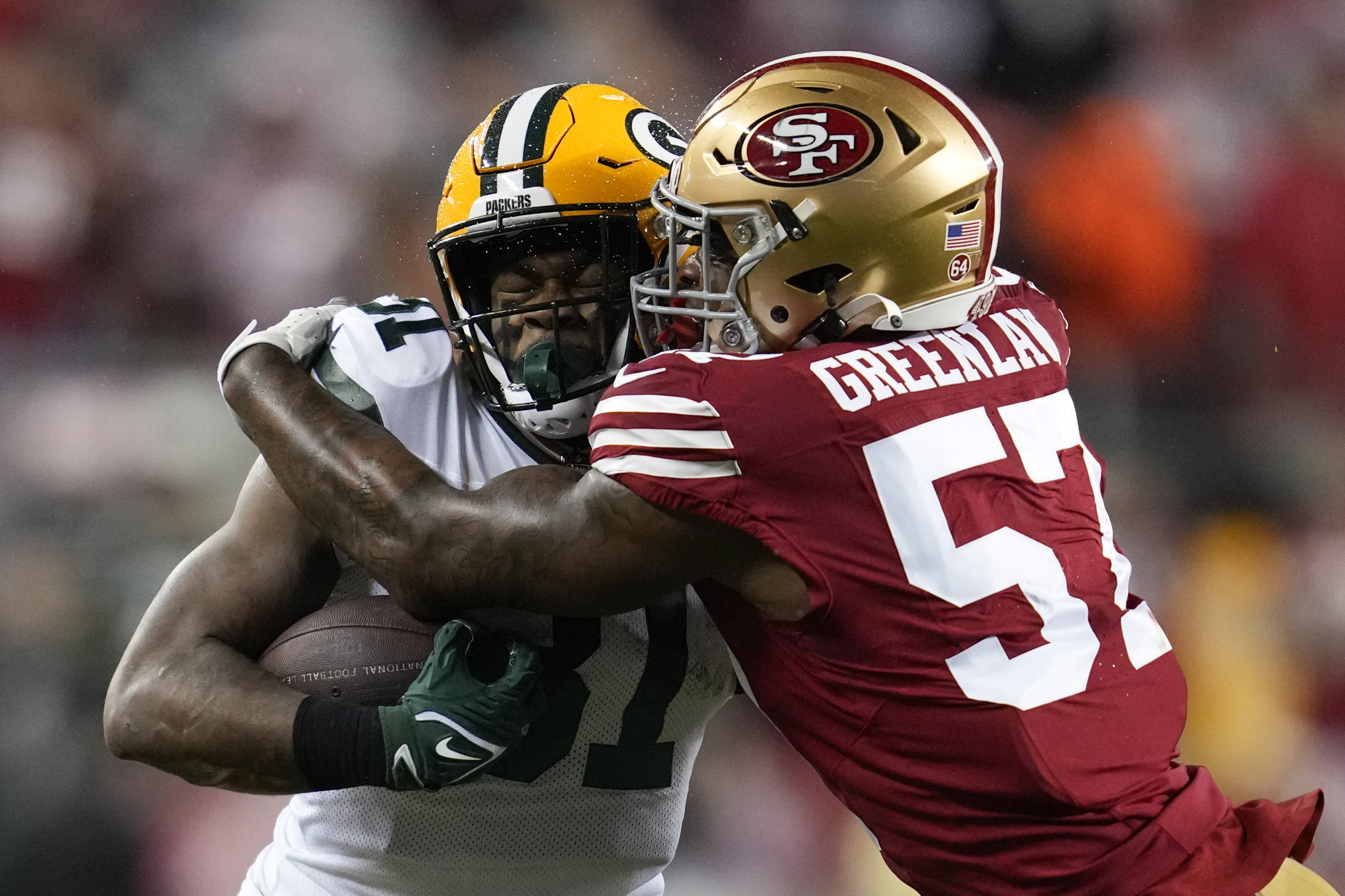 Green Bay Packers running back Emanuel Wilson (31) is tackled by San Francisco 49ers linebacker Dre Greenlaw (57) during an NFL football game Sunday, Jan. 21, 2024, in Inglewood, Calif. (AP Photo/Ashley Landis) (Ashley Landis)