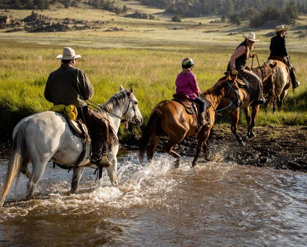 Gottenborg family crosses Taryall River on the Eagle Rock Ranch
