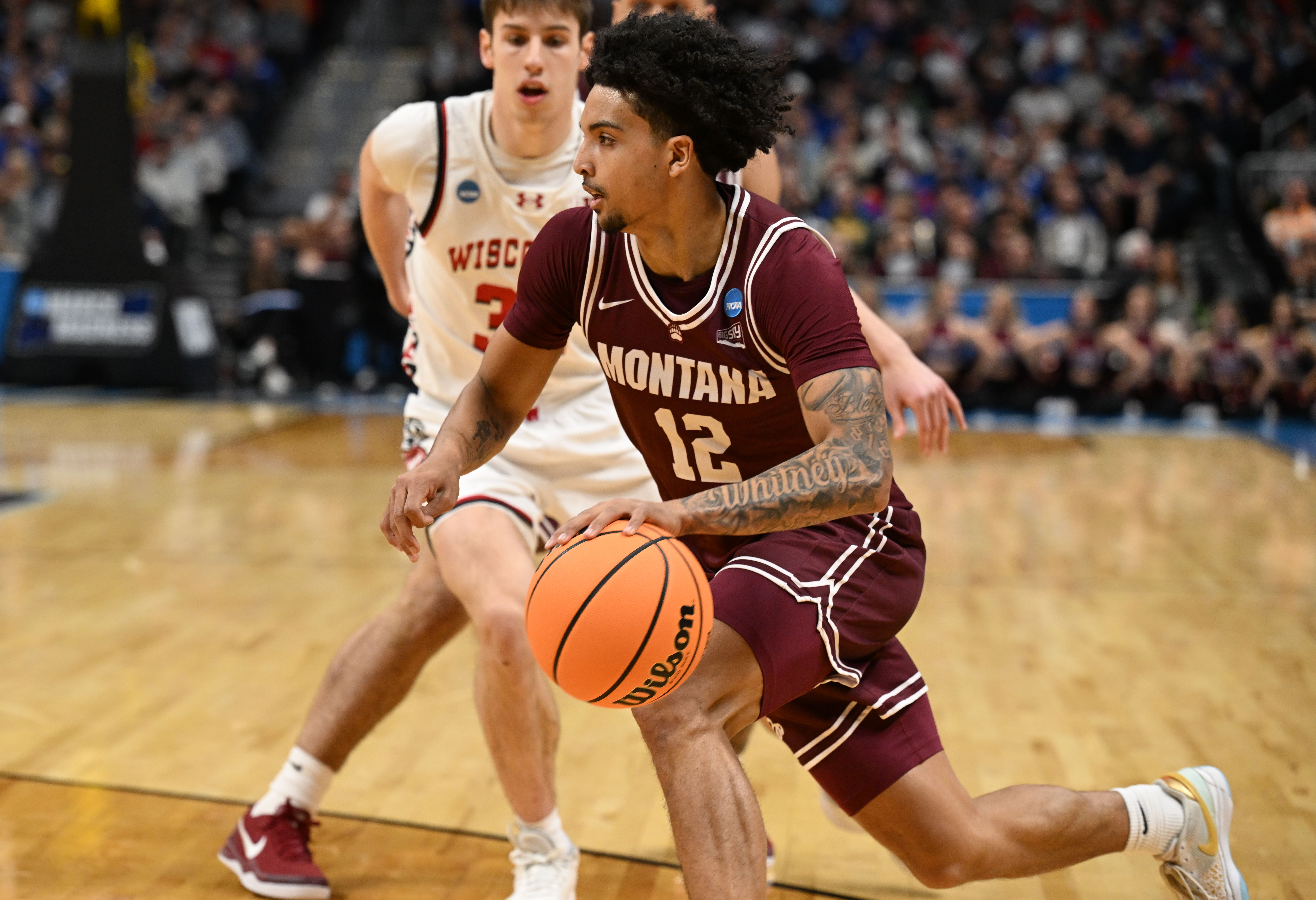 Montana Grizzlies guard Brandon Whitney (12) pushes past the Wisconsin defense in the first half of the Montana vs Wisconsin game during NCAA March Madness on Thursday, March 20, 2025 (Stephen Swofford, Denver Gazette) (StephenSwoffordPhotographerstephen.swofford@gazette.comhttps://secure.gravatar.com/avatar/1ddcaf11c5d70eaa58546ddc4e038687?d=mm&r=g)