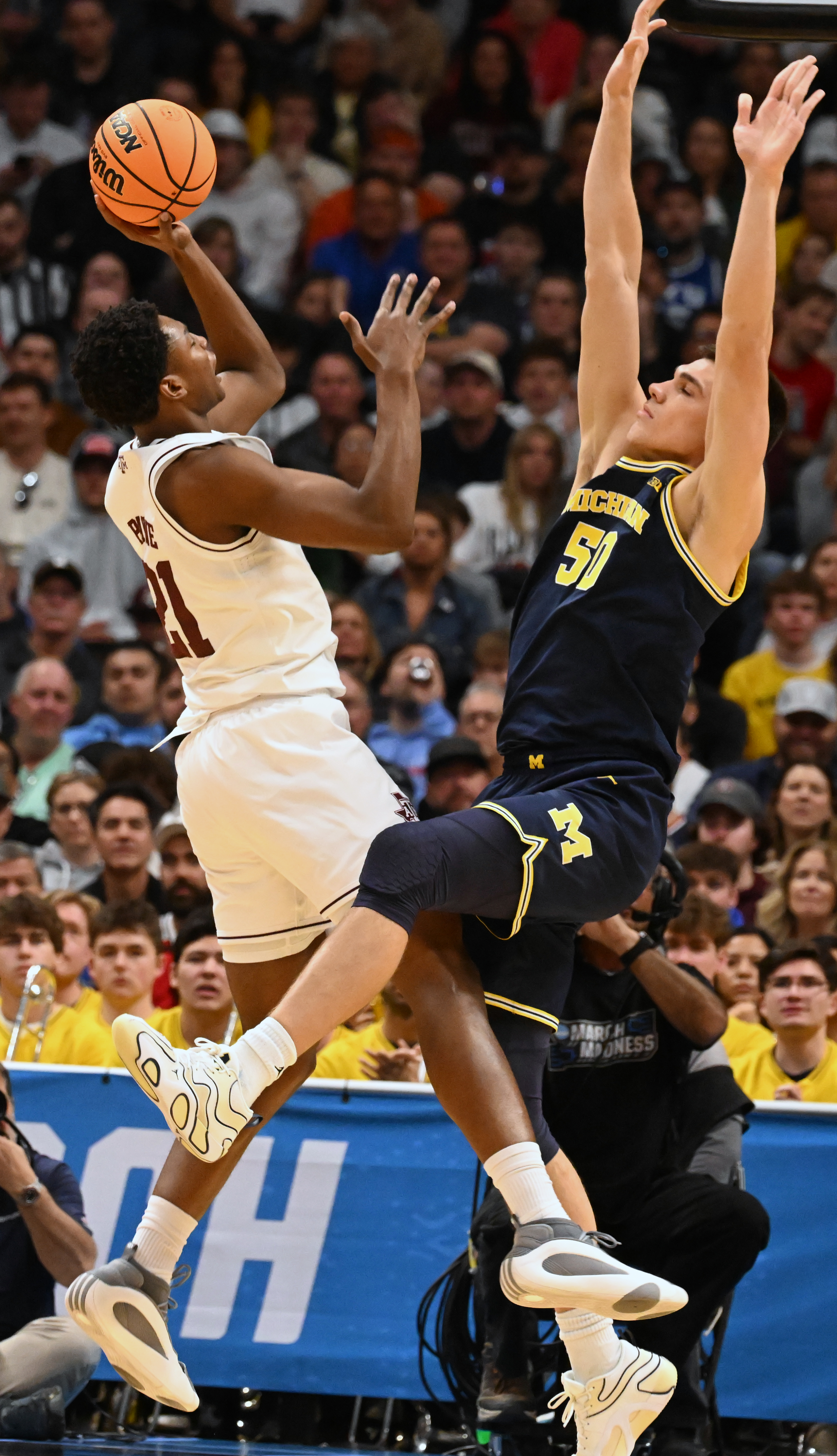Michigan Wolverines center Vladislav Goldin (50) defends Texas A&M Aggies forward Pharrel Payne (21) during the second half of the second round of March Madness at Ball Arena on Saturday, March 22, 2025. Michigan won the game 91-79 and will be going to the Sweet Sixteen. (Jerilee Bennett,The Gazette)