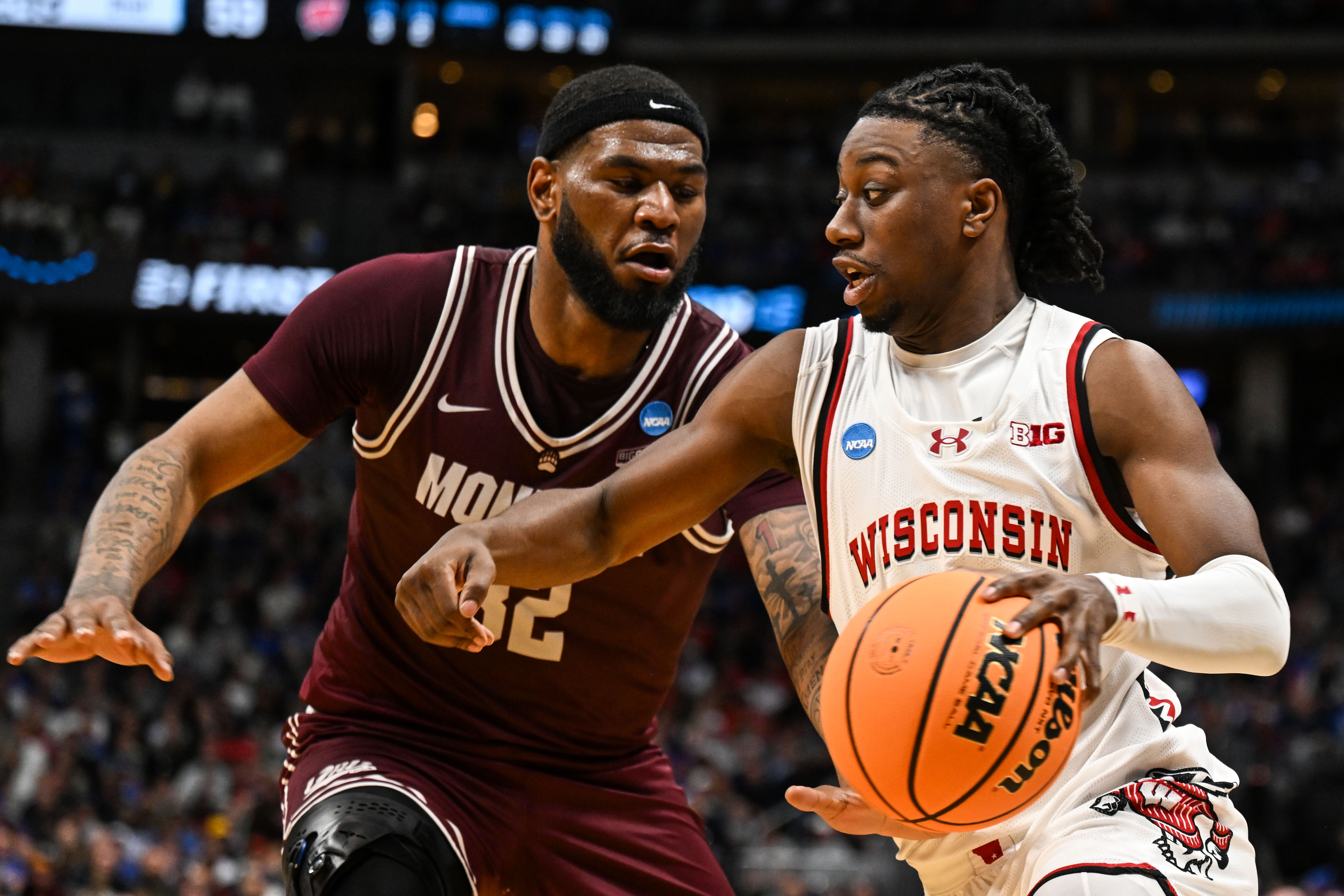 Montana Grizzlies forward Te'Jon Sawyer (32) guards against Wisconsin Badgers guard John Blackwell (25) as he drives to the basket in the first half of the Montana vs Wisconsin game during NCAA March Madness on Thursday, March 20, 2025 (Stephen Swofford, Denver Gazette) (StephenSwoffordPhotographerstephen.swofford@gazette.comhttps://secure.gravatar.com/avatar/1ddcaf11c5d70eaa58546ddc4e038687?d=mm&r=g)