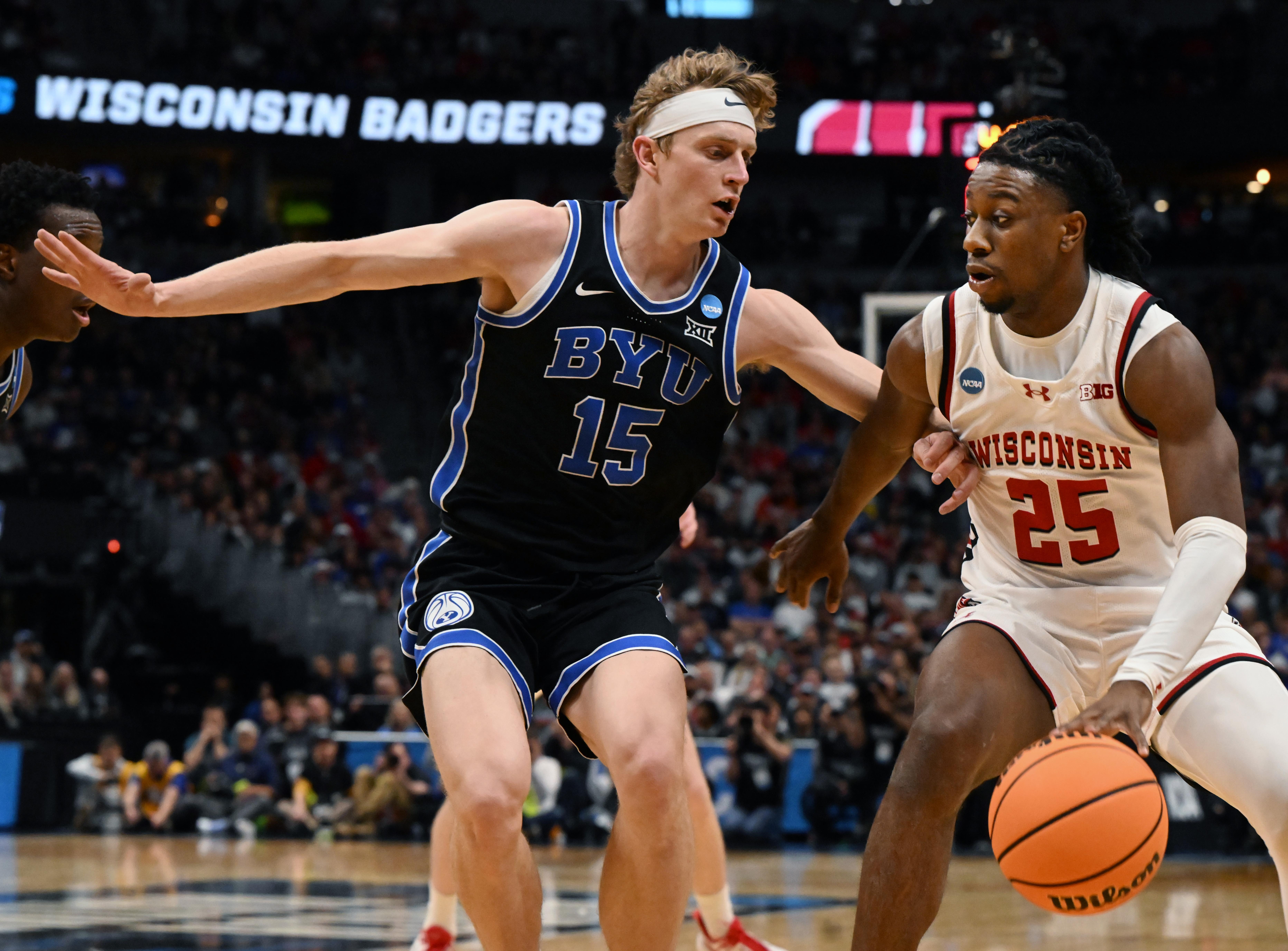 Brigham Young Cougars forward Richie Saunders (15) defends Wisconsin Badgers guard John Blackwell (25) during the second round of March Madness at Ball Arena on Saturday, March 22, 2025. BYU won the game 91-89 and will be going to the Sweet Sixteen. (Jerilee Bennett,The Gazette)