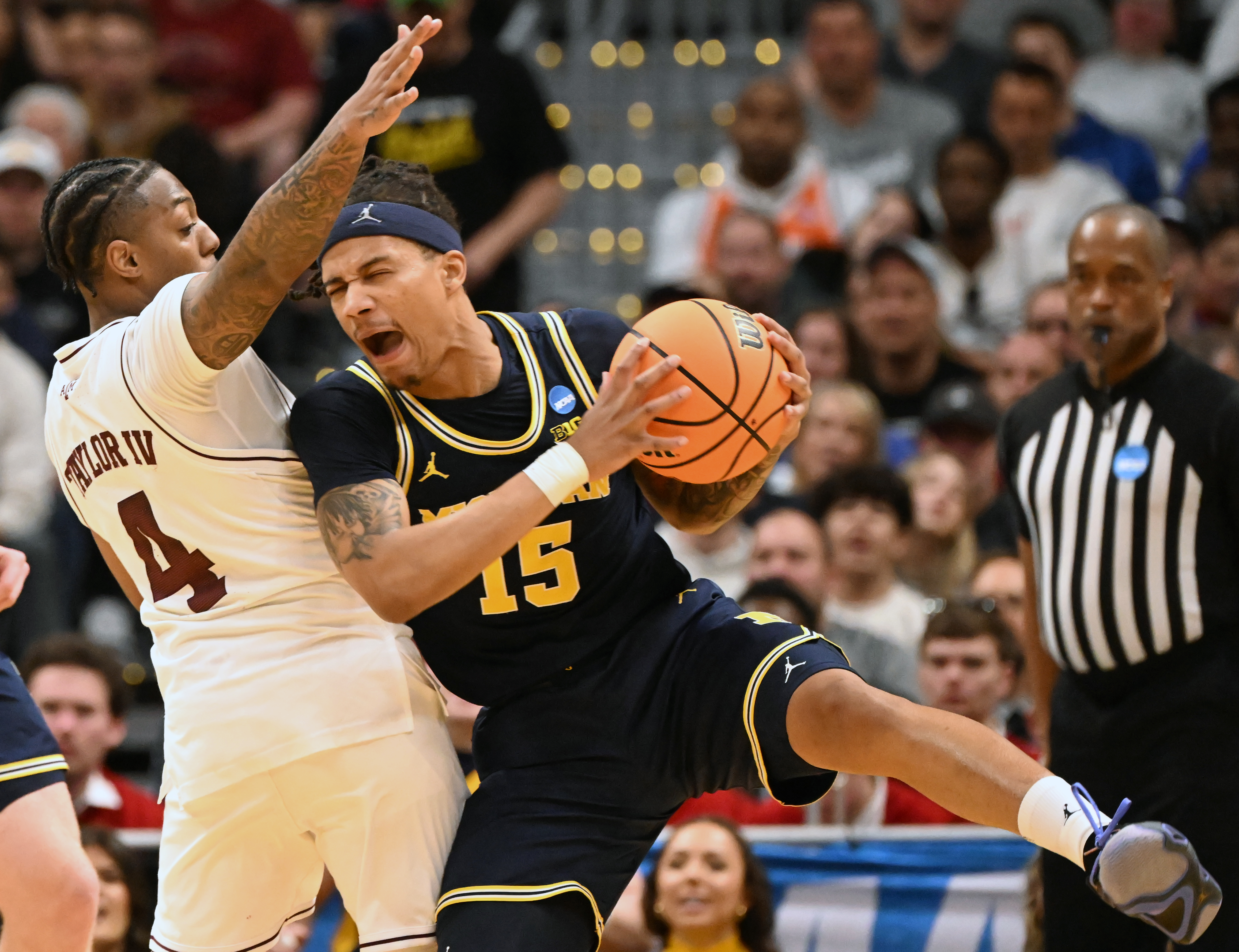 Michigan Wolverines guard Rubin Jones (15) comes down with the ball while being defended by Texas A&M Aggies guard Wade Taylor IV (4) during the second half of the second round of March Madness at Ball Arena on Saturday, March 22, 2025. Michigan won the game 91-79 and will be going to the Sweet Sixteen. (Jerilee Bennett,The Gazette)