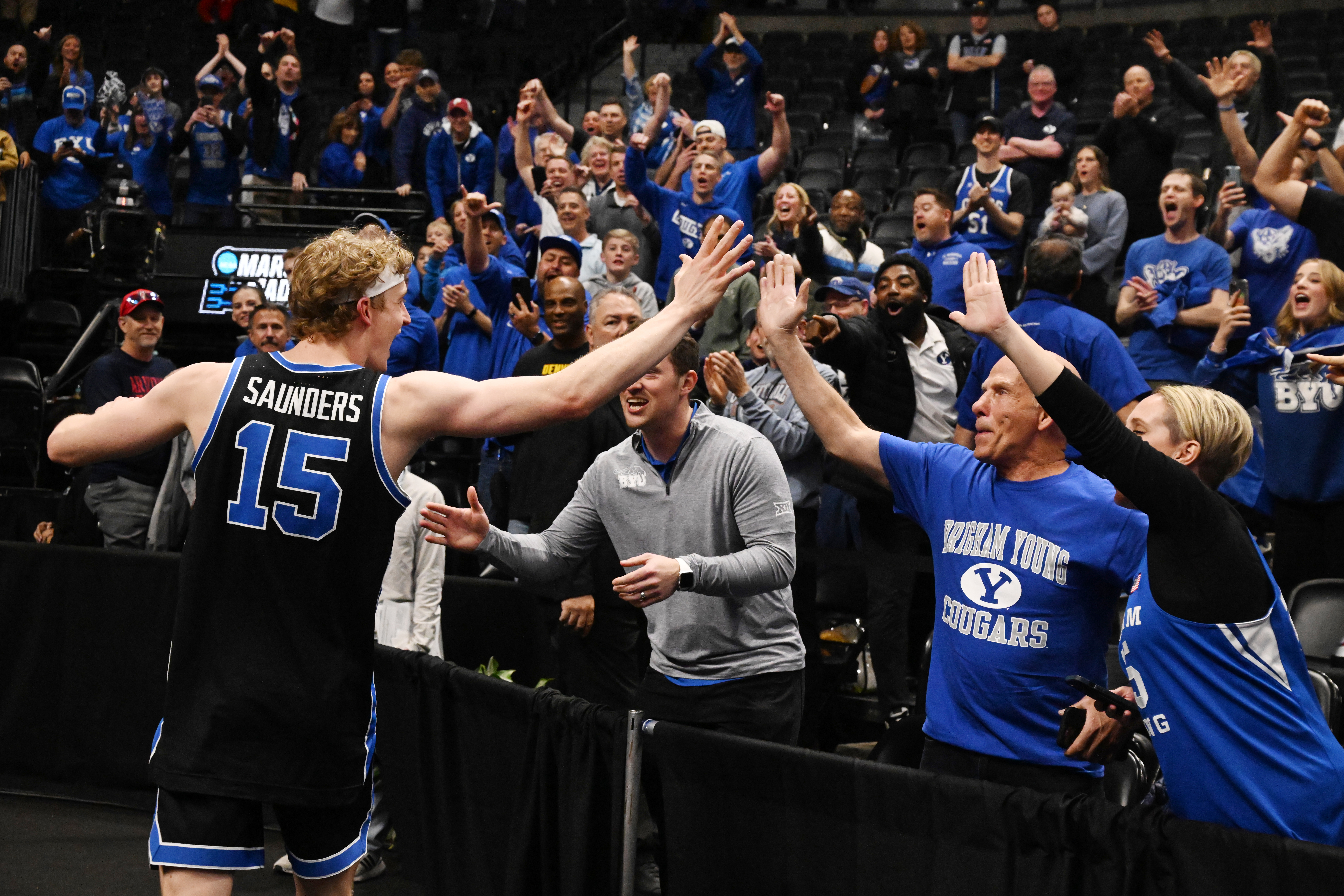 Brigham Young Cougars forward Richie Saunders (15) high fives with fans after winning the second round of March Madness at Ball Arena on Saturday, March 22, 2025. BYU won the game 91-89 and will be going to the Sweet Sixteen. (Jerilee Bennett,The Gazette)