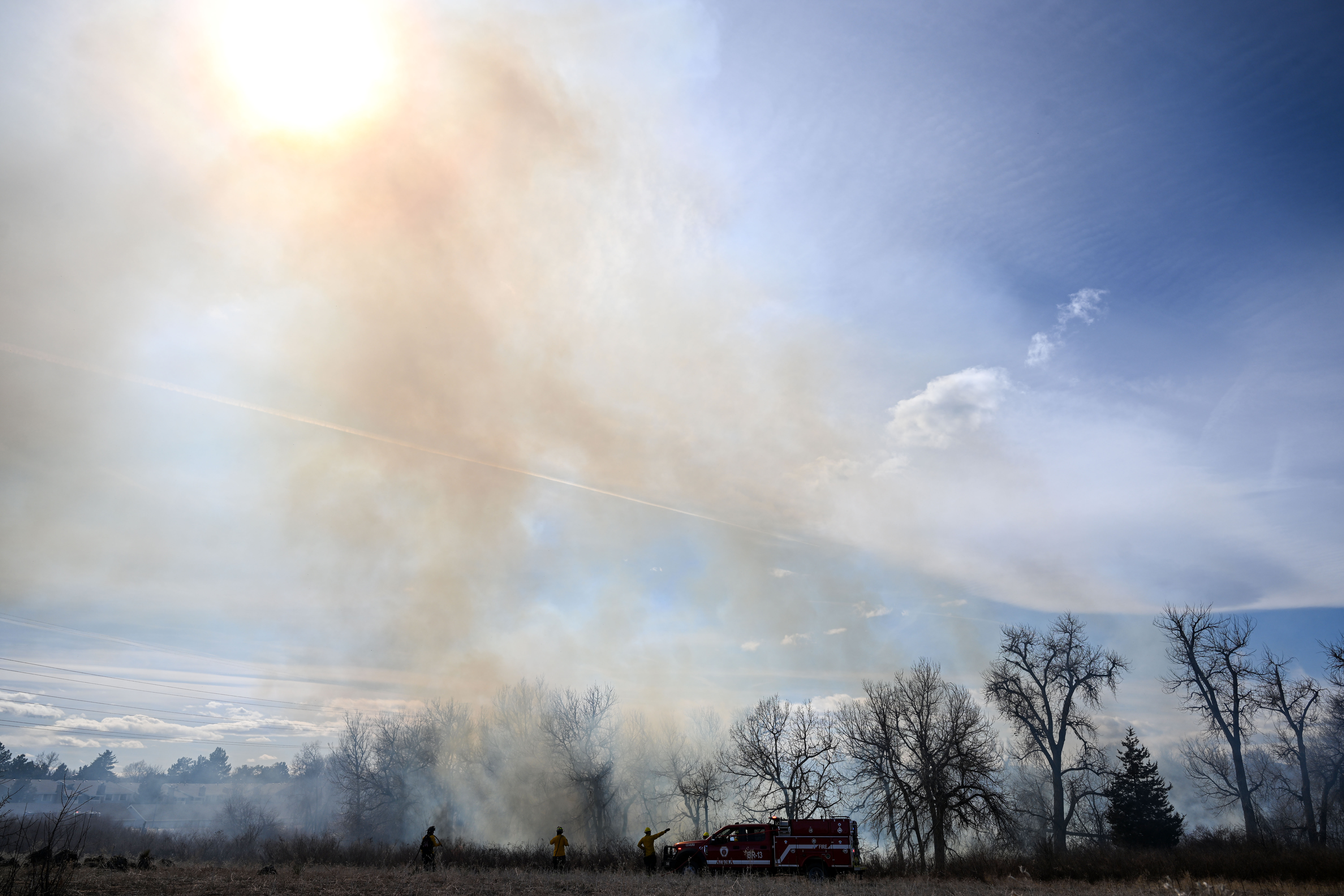 Aurora firefighters combat a wildfire at Jewell Wetlands Park in Aurora on Friday, March 21, 2025. (Stephen Swofford, Denver Gazette) (StephenSwoffordPhotographerstephen.swofford@gazette.comhttps://secure.gravatar.com/avatar/1ddcaf11c5d70eaa58546ddc4e038687?d=mm&r=g)