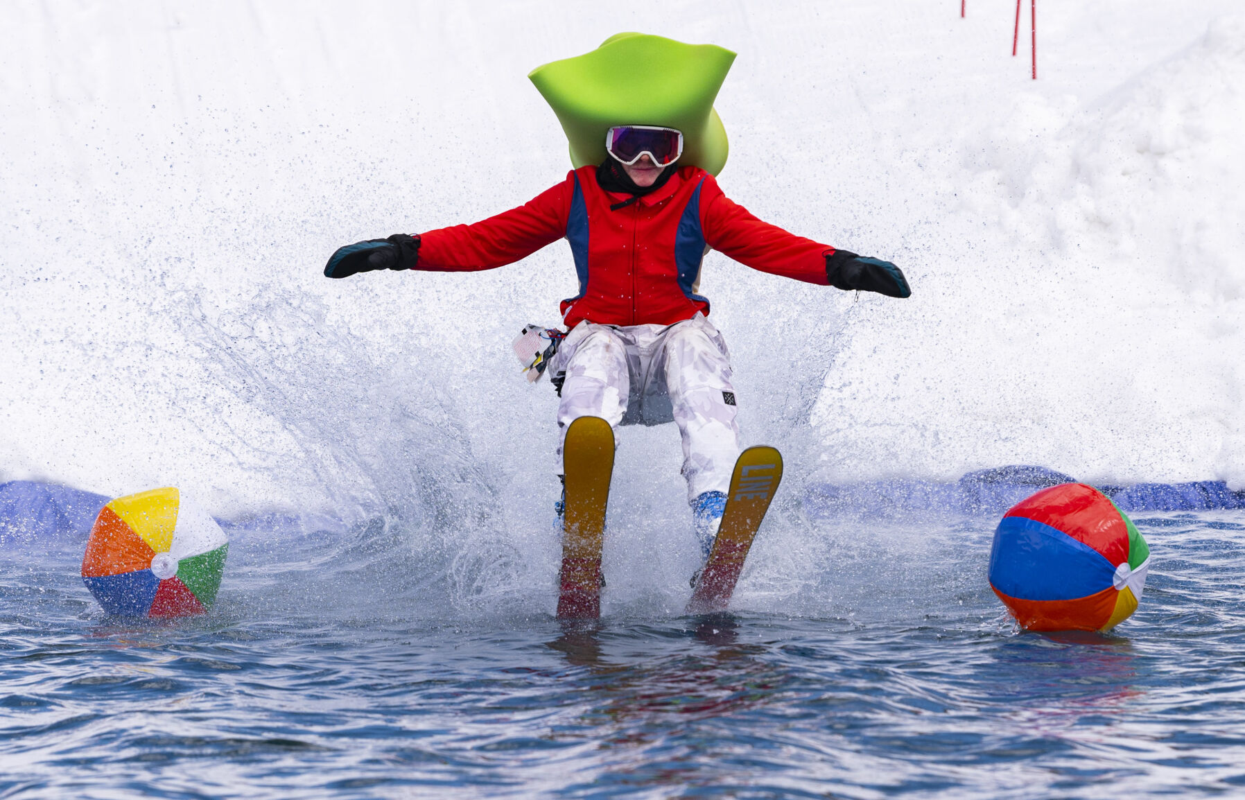 Devin Lindenmeyr, 14, skims across the water Saturday, April 2, 2022, during the 2022 Pond Skim on the closing weekend of skiing at Crested Butte Mountain Resort. Sunday is the last day at the Colorado ski resort. (Christian Murdock/The Gazette)