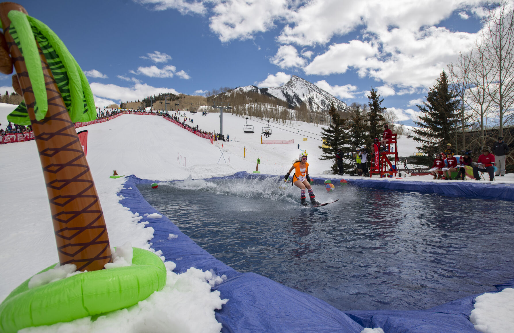 Alley Rubadeau skis across the water Saturday, April 2, 2022, during the 2022 Pond Skim on the closing weekend of skiing at Crested Butte Mountain Resort.  (The Gazette, Christian Murdock) (Christian Murdock/The Gazette)