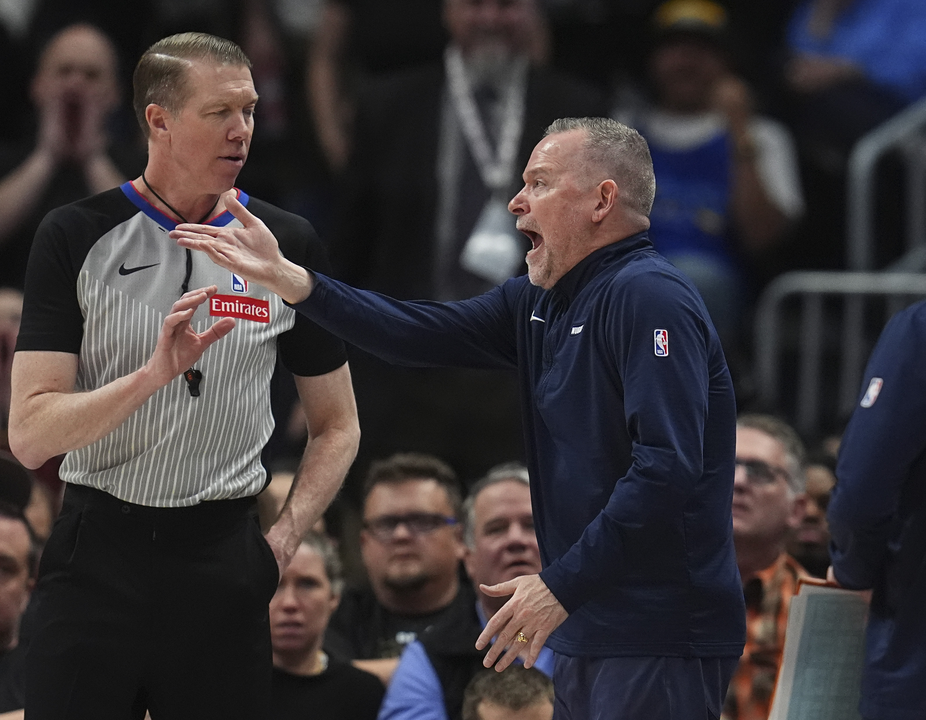 Denver Nuggets head coach Michael Malone, right, argues for a call with referee Ed Malloy in the second half of an NBA basketball game against the Sacramento Kings Wednesday, March 5, 2025, in Denver. (AP Photo/David Zalubowski) (David Zalubowski)
