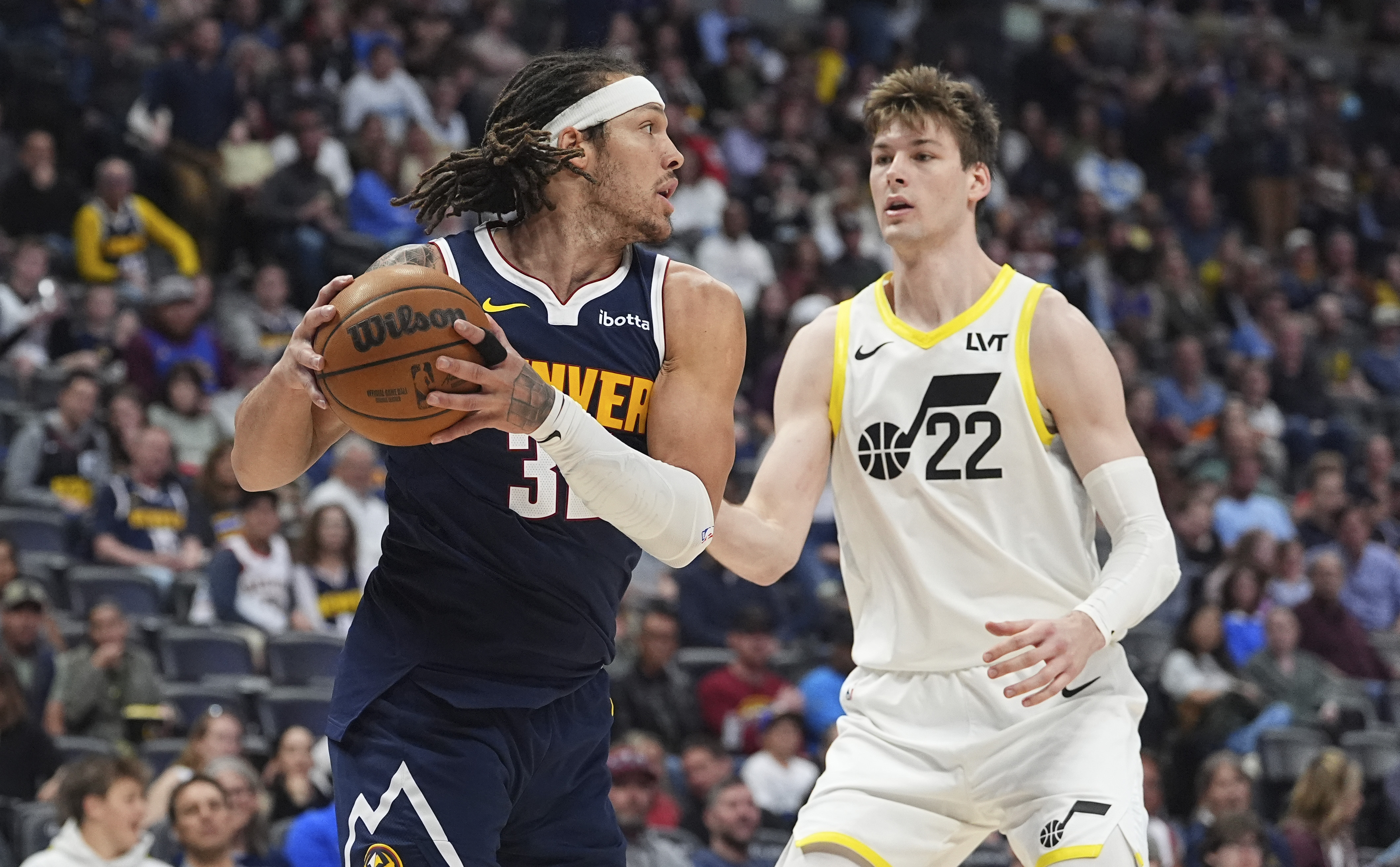 Denver Nuggets forward Aaron Gordon, left, pulls in a rebound as Utah Jazz forward Kyle Filipowski defends in the second half of an NBA basketball game Friday, March 28, 2025, in Denver. (AP Photo/David Zalubowski) (David Zalubowski)