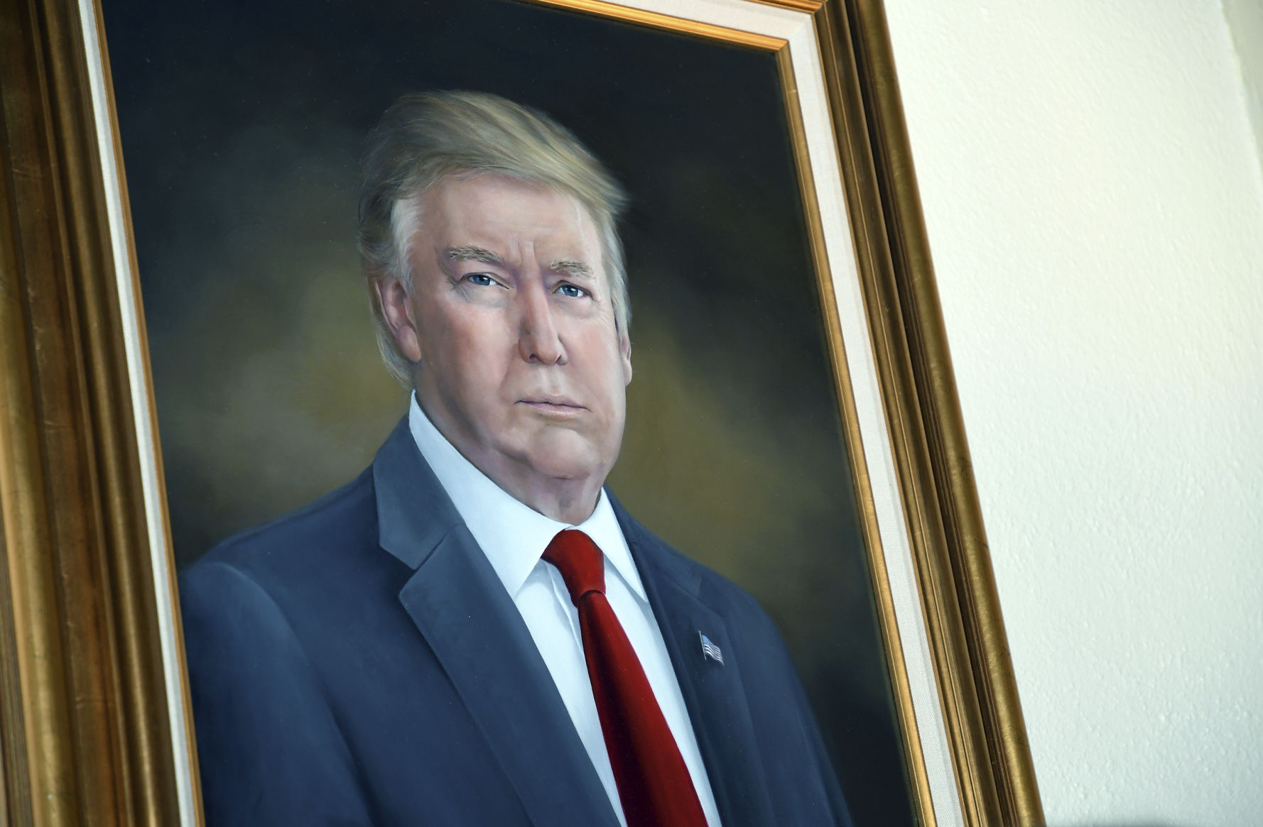 President Donald Trump's portrait hangs in the Colorado Capitol after an unveiling ceremony Thursday, Aug. 1, 2019, in Denver. Colorado Republicans raised more than $10,000 through a GoFundMe account to commission the portrait, which was painted by Sarah Boardman, an artist who also produced the Capitol's portrait of President Barack Obama. (AP Photo/Thomas Peipert) (Thomas Peipert)