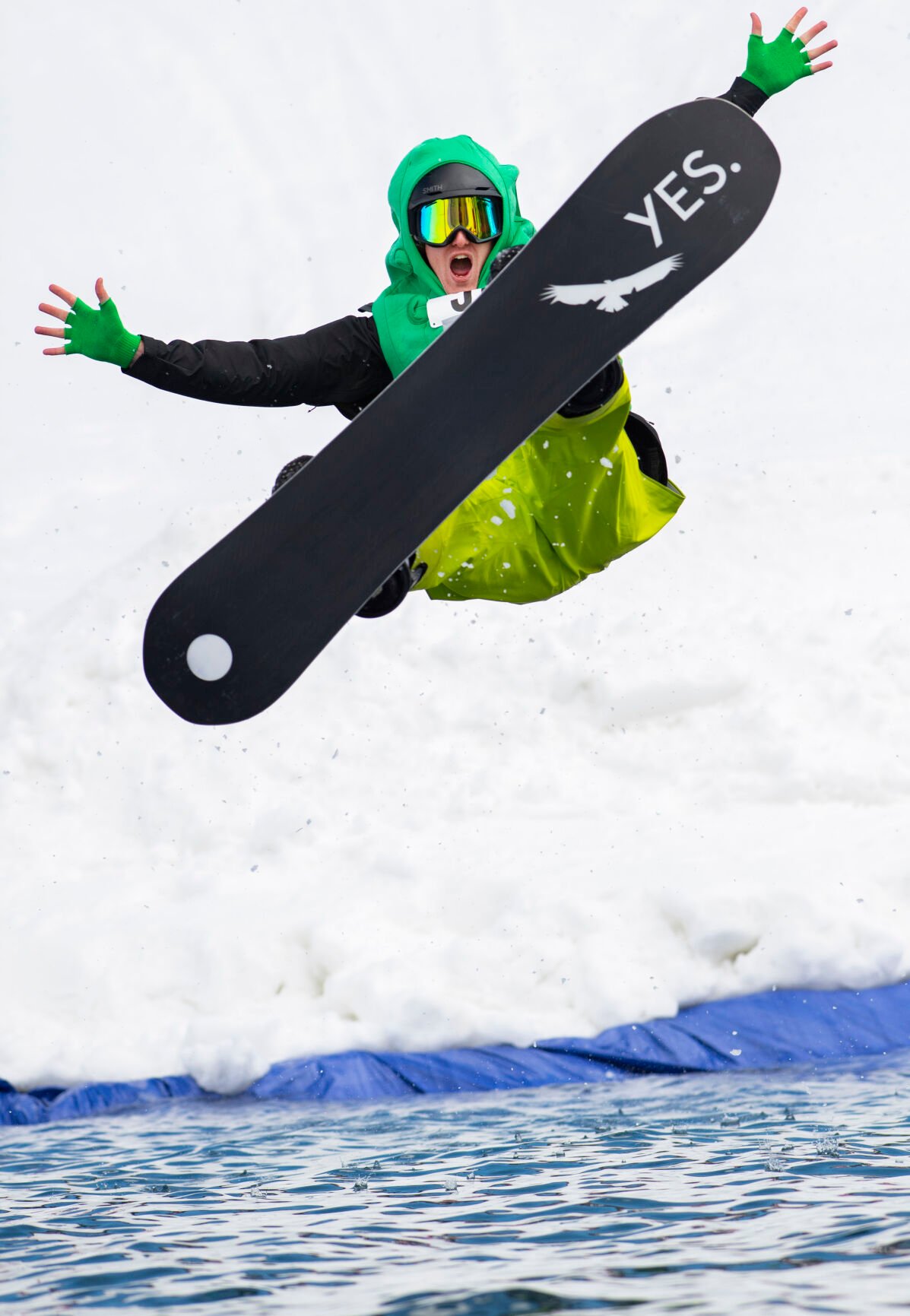 Christian Murdock/The Gazette Snowboarder Sterling Douglass sails to a wet ending as he crashes into the water Saturday, April 2, 2022, during the 2022 Pond Skim on the closing weekend of skiing at Crested Butte Mountain Resort. Sunday is the last day at the Colorado ski resort. (Christian Murdock/The Gazette)