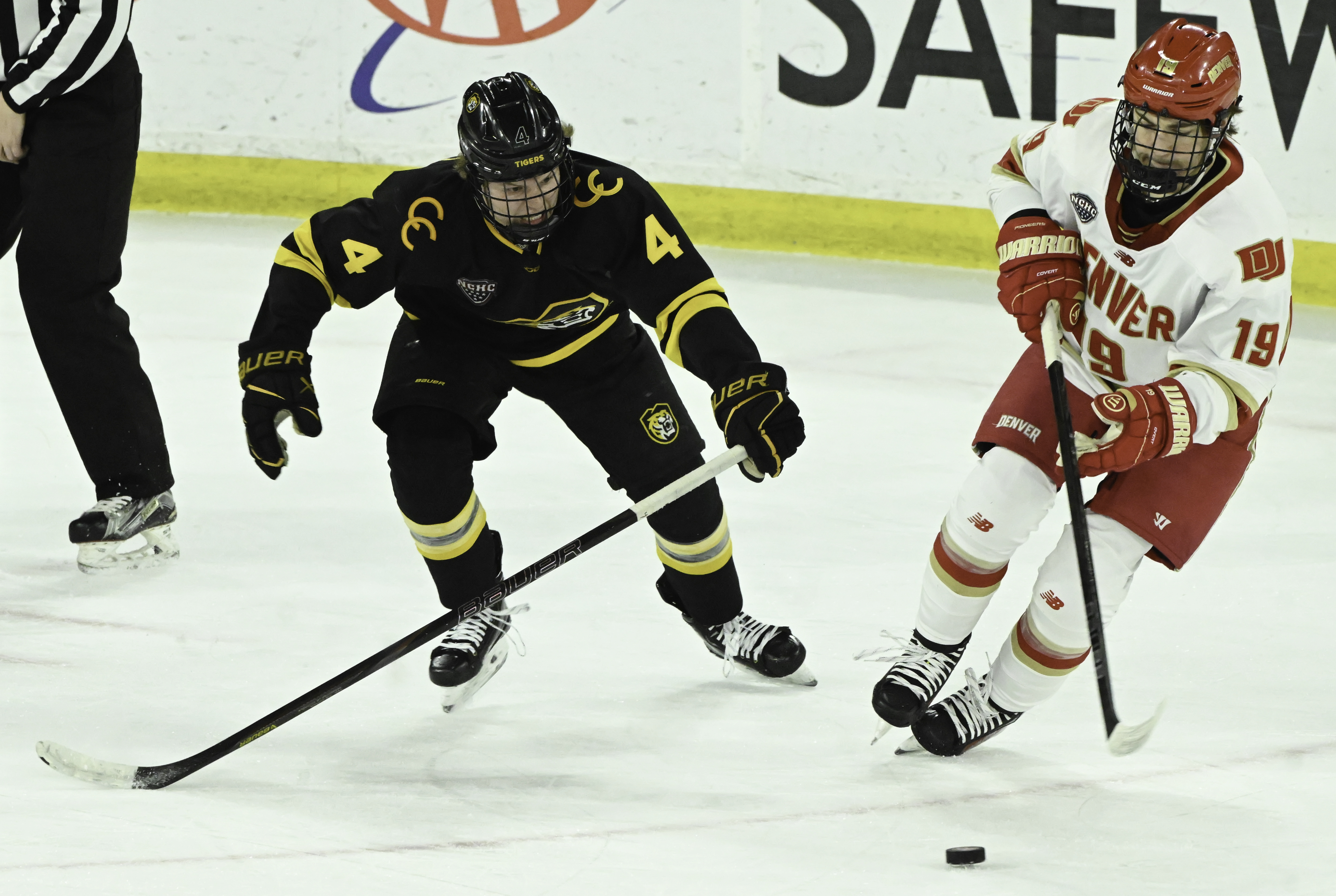 DU’s Jared Wright controls the puck while being defended by CC’s Max Burkholder during a game at Magness Arena on Sunday, March 16, 2025. DU won the game 9-2. (Jerilee Bennett)