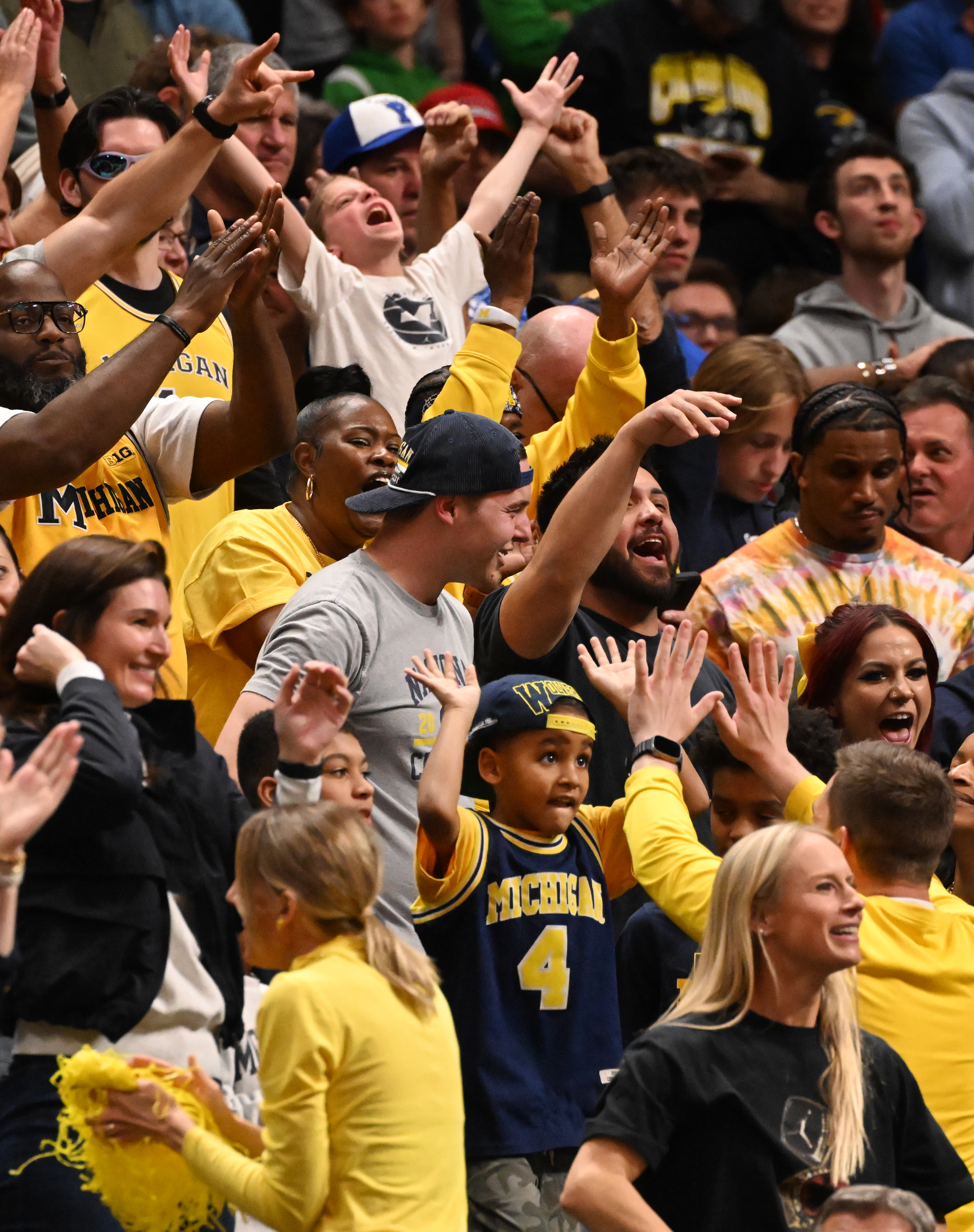 Michigan fans go wild as their team starts to go ahead in the ballgame during the second half of the second round of March Madness at Ball Arena on Saturday, March 22, 2025. Michigan won the game 91-79 and will be going to the Sweet Sixteen. (Jerilee Bennett,The Gazette)