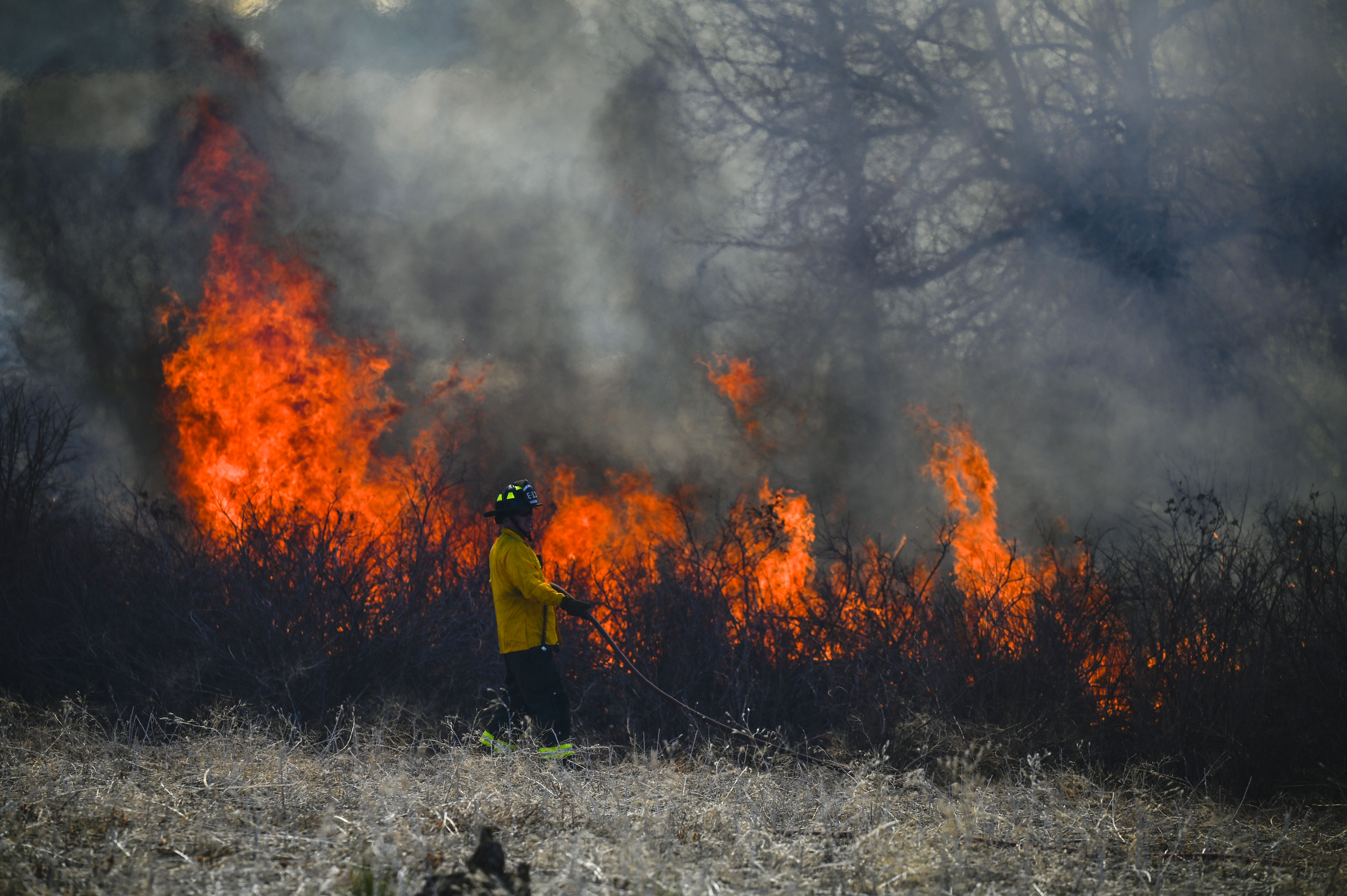 Aurora firefighters combat a wildfire at Jewell Wetlands Park in Aurora on Friday, March 21, 2025. (Stephen Swofford, Denver Gazette) (StephenSwoffordPhotographerstephen.swofford@gazette.comhttps://secure.gravatar.com/avatar/1ddcaf11c5d70eaa58546ddc4e038687?d=mm&r=g)