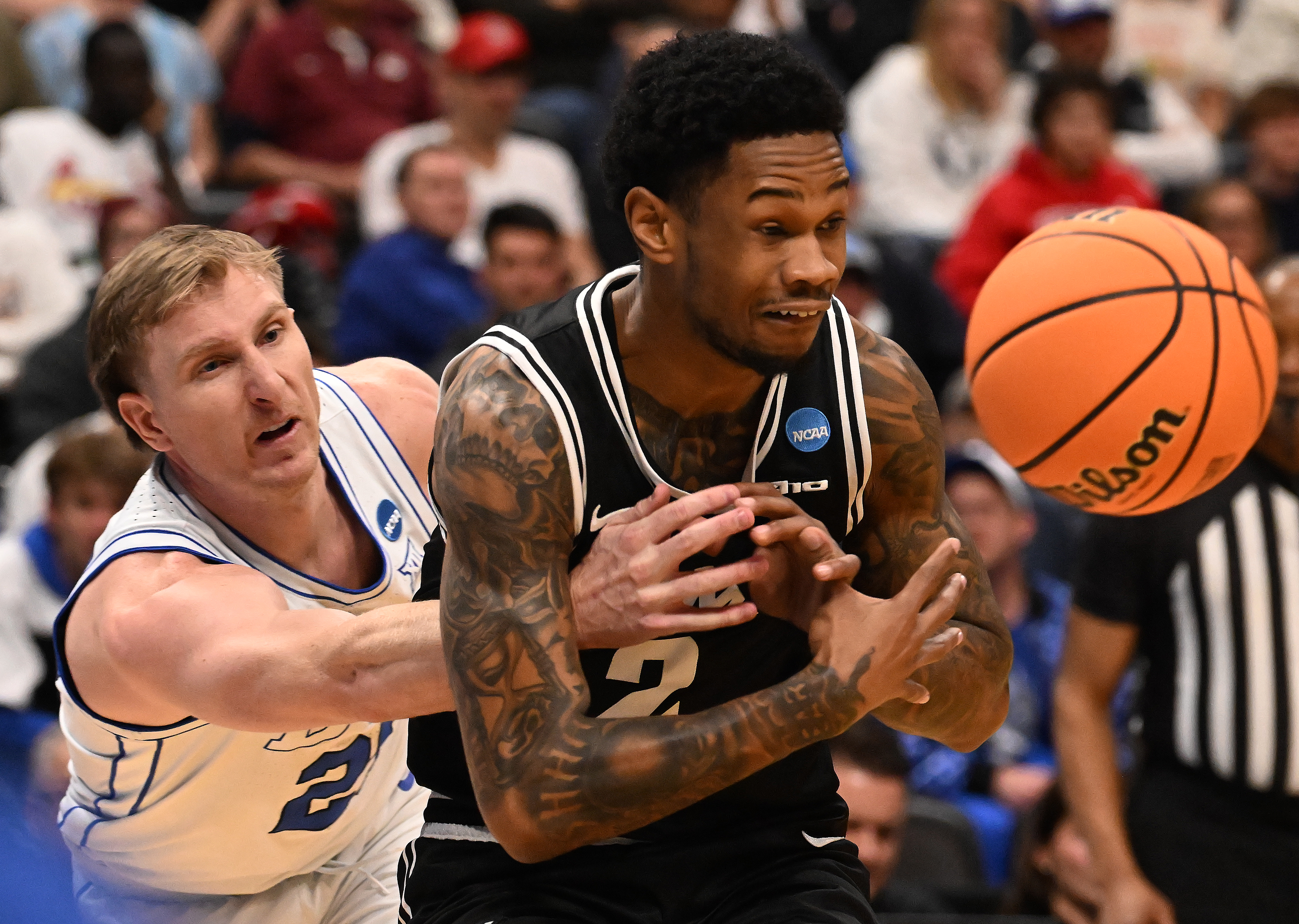 Brigham Young Cougars guard Trevin Knell (21) knocks the ball away from Virginia Commonwealth Rams guard Zeb Jackson (2) during the first half of a round 1 game of the NCAA March Madness tournament at Ball Arena on Thursday, March 20, 2025. BYU defeated VCU 80-71. (Jerilee Bennett,The Gazette)