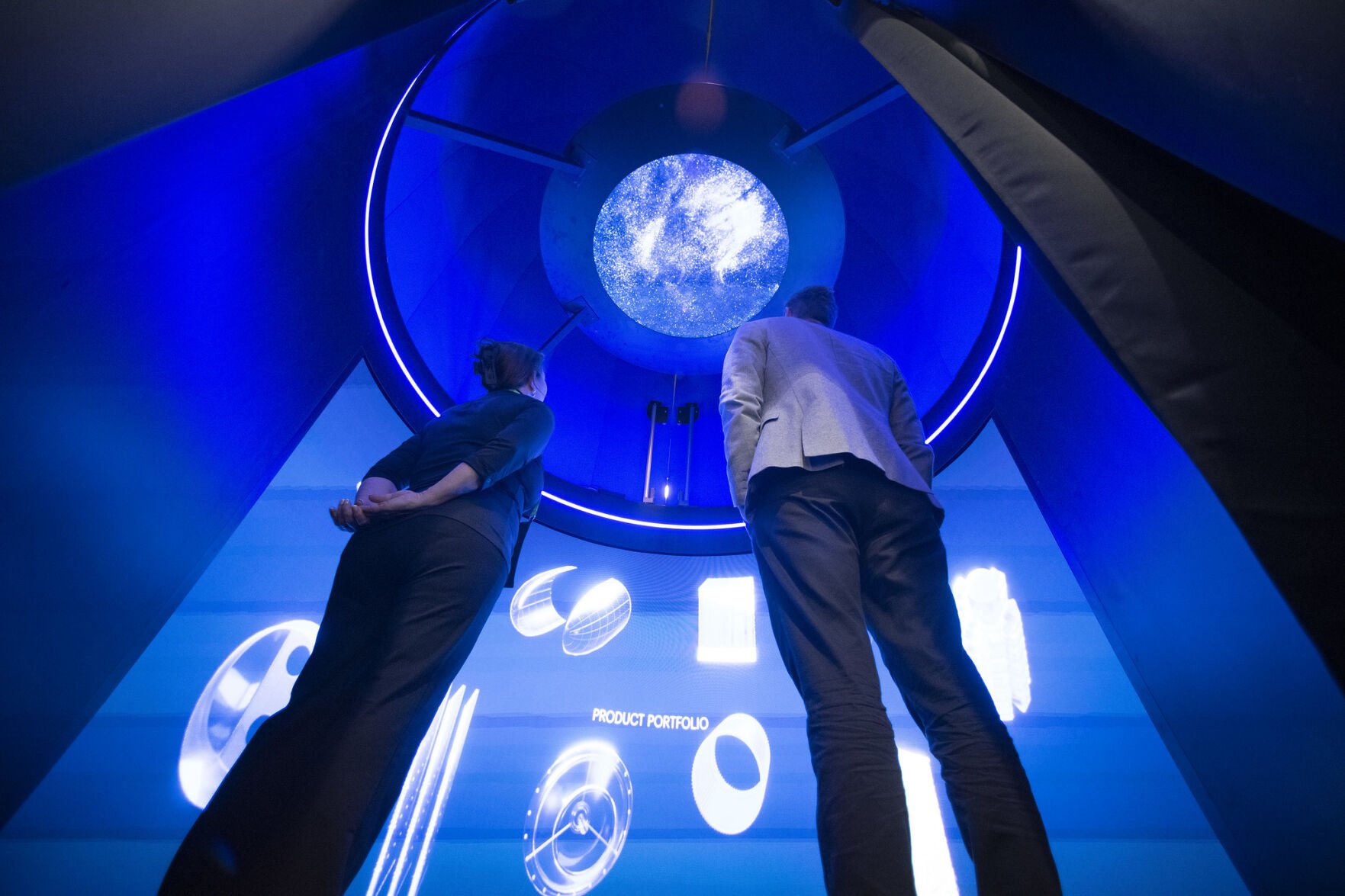 Visitors look at an exhibit during the 40th Space Symposium event Monday inside the BAE Systems Exhibit Centers at The Broadmoor in Colorado Springs. (Chuck Bigger, Space Foundation)