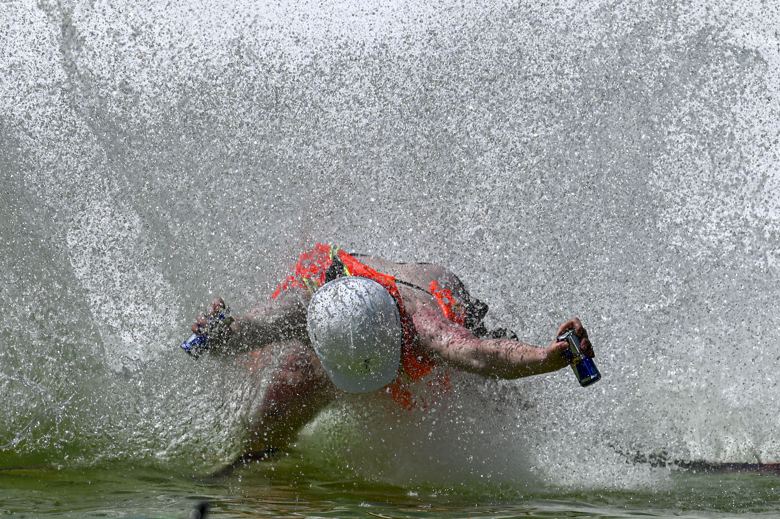 A skier falls into a pool of water at the base of Winter Park during the Spring Splash event to celebrate the last day of the season on Sunday, April 27, 2025 (Stephen Swofford, Denver Gazette) (StephenSwoffordPhotographerstephen.swofford@gazette.comhttps://secure.gravatar.com/avatar/1ddcaf11c5d70eaa58546ddc4e038687?d=mm&r=g)