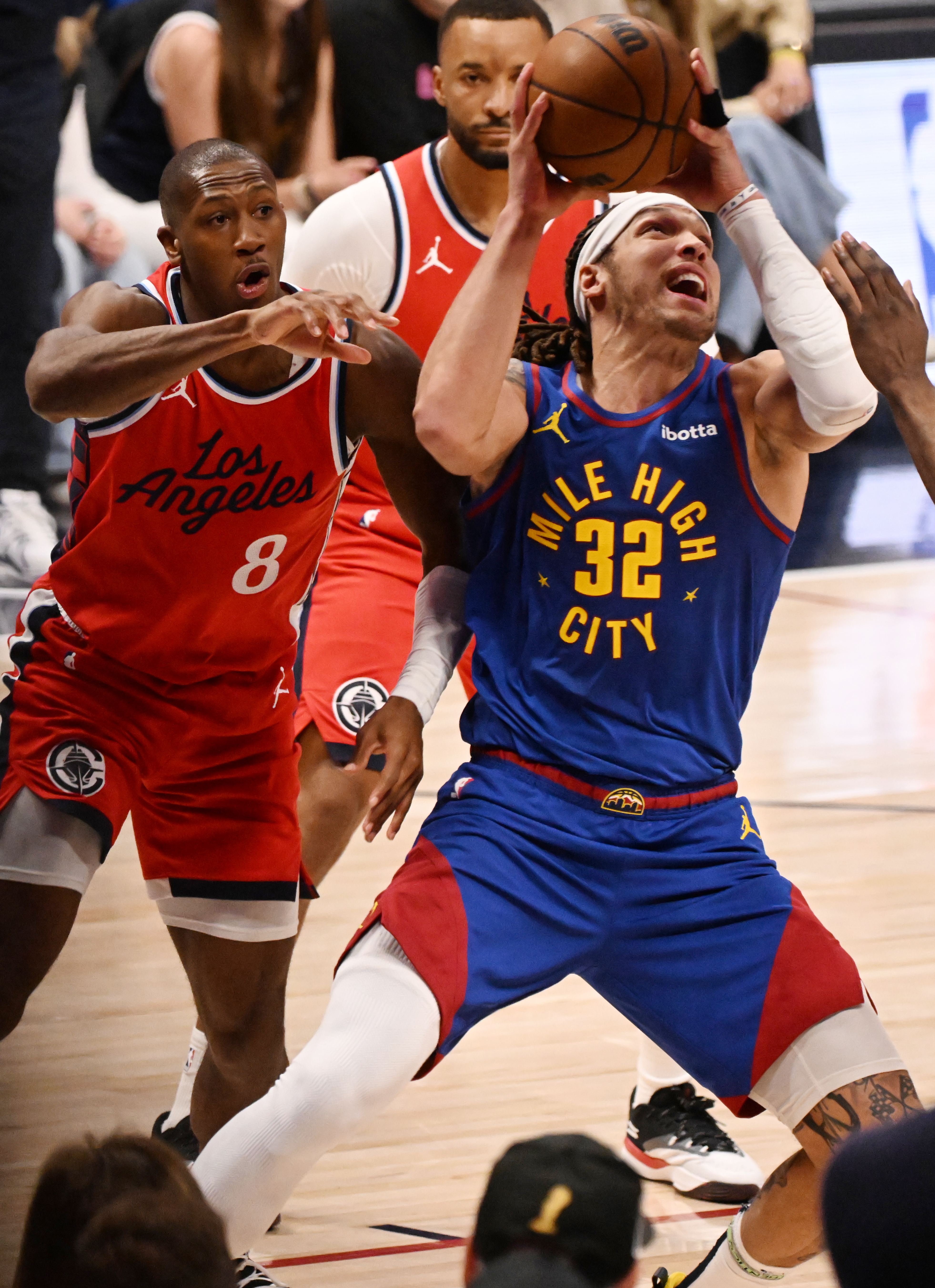 Nuggets Aaron Gordon powers past Cliippers Kris Dunn to score in overtime of the first series of the NBA playoffs at Ball Arena on Saturday, April 19, 2025. The Nuggets won the game in overtime 112-110. (Jerilee Bennett,The Gazette)