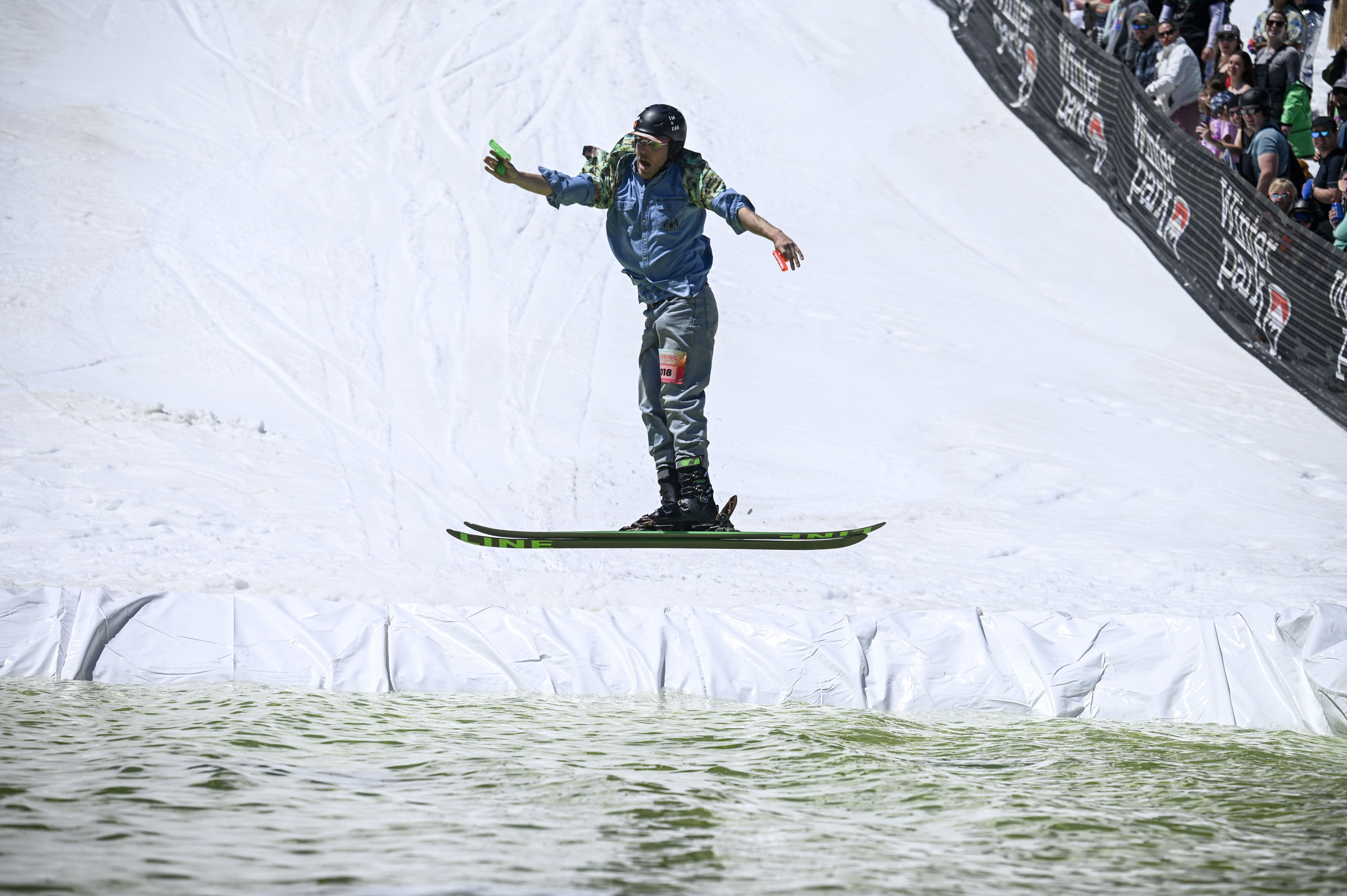 A skier jumps into a pool of water at the base of Winter Park during the Spring Splash event to celebrate the last day of the season on Sunday, April 27, 2025 (Stephen Swofford, Denver Gazette) (StephenSwoffordPhotographerstephen.swofford@gazette.comhttps://secure.gravatar.com/avatar/1ddcaf11c5d70eaa58546ddc4e038687?d=mm&r=g)