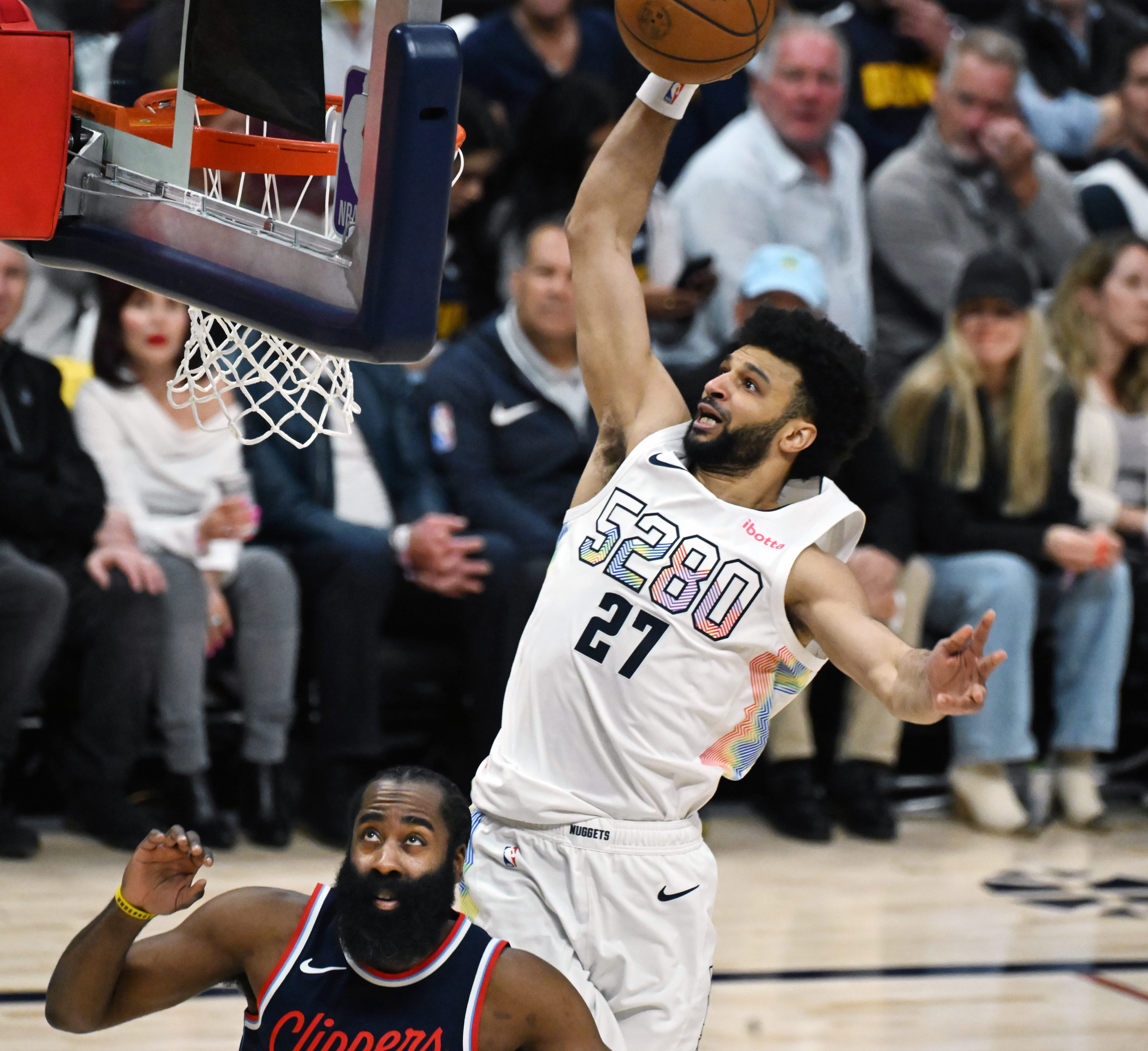 Denver Nuggets guard Jamal Murray (27) flies over LA Clippers guard James Harden (1) during the 1st quarter of game 5 of the first round of the Western Championships at Ball Arena on Tuesday, April 29, 2025. (Jerilee Bennett,The Gazette)