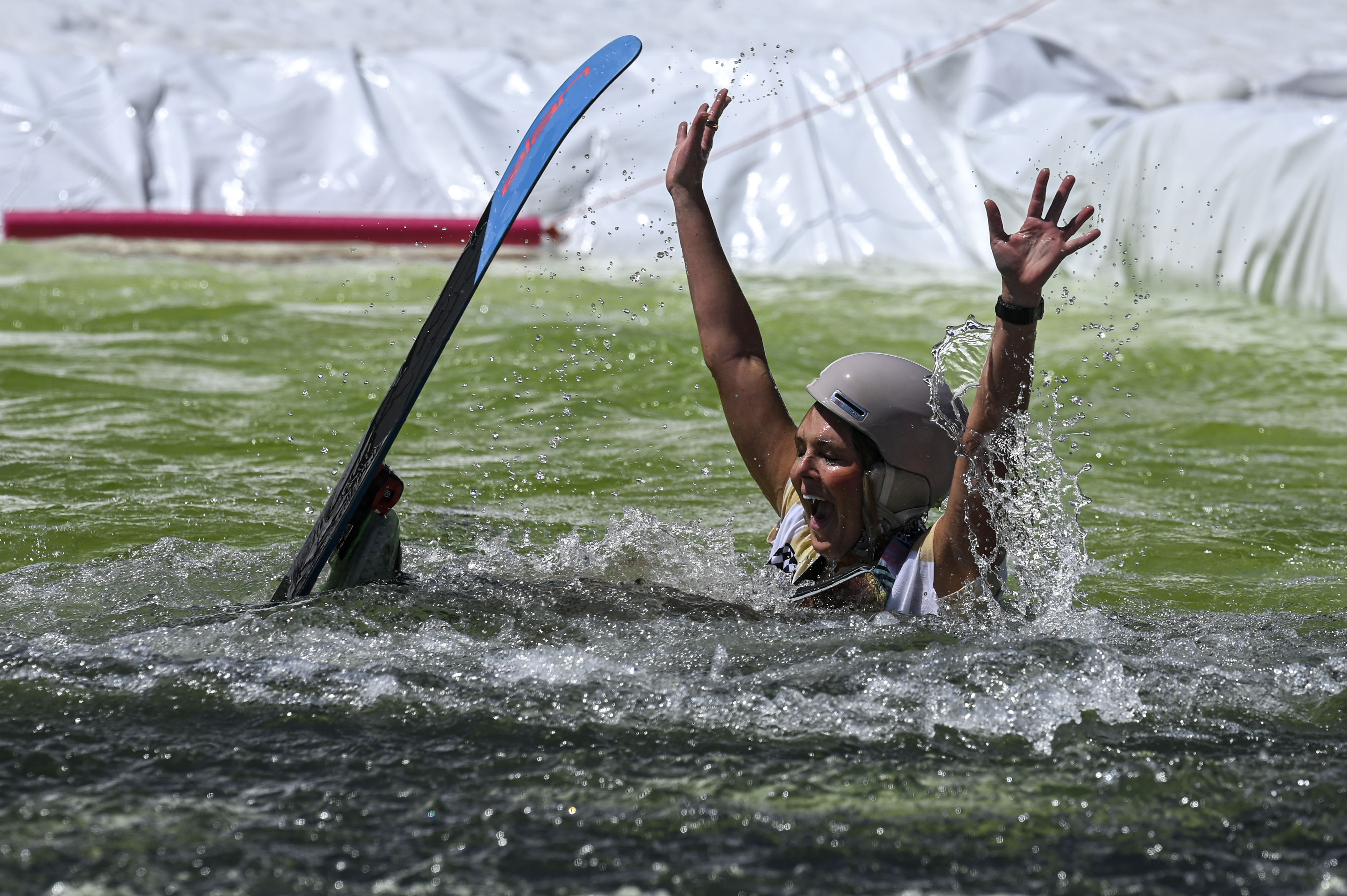 A skier falls into a pool of water at the base of Winter Park during the Spring Splash event to celebrate the last day of the season on Sunday, April 27, 2025 (Stephen Swofford, Denver Gazette) (StephenSwoffordPhotographerstephen.swofford@gazette.comhttps://secure.gravatar.com/avatar/1ddcaf11c5d70eaa58546ddc4e038687?d=mm&r=g)
