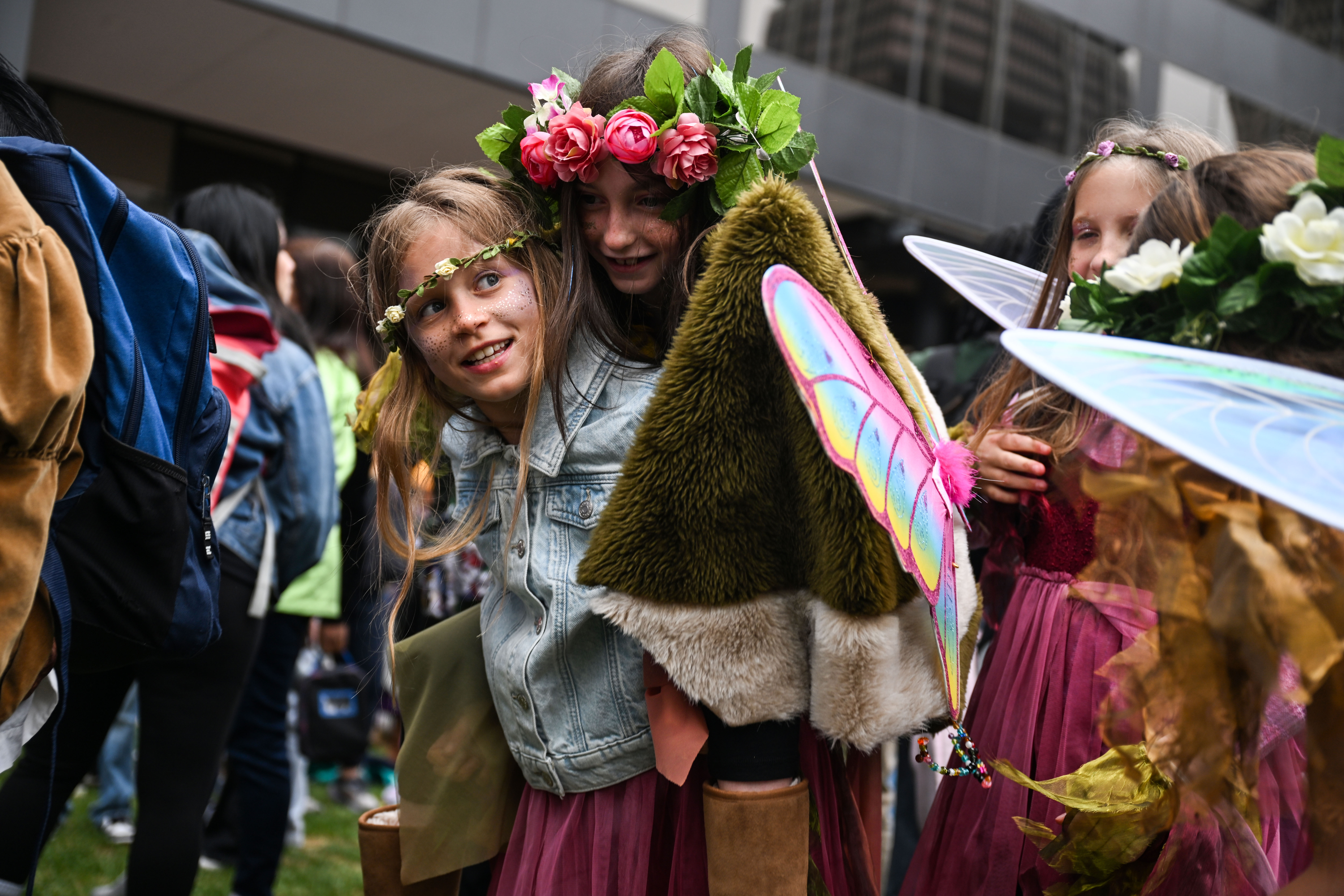 Francis Fuller, 9, lifts her friend Maya Pertain, 10, onto her back for a better view at Skyline Park in Denver during the opening ceremony for the 41st Annual DPS Shakespeare Festival on Friday, April 25, 2025. Students marched from Skyline park to the Denver Center for the Performing Arts to kick off the festival. (Stephen Swofford, Denver Gazette) (StephenSwoffordPhotographerstephen.swofford@gazette.comhttps://secure.gravatar.com/avatar/1ddcaf11c5d70eaa58546ddc4e038687?d=mm&r=g)