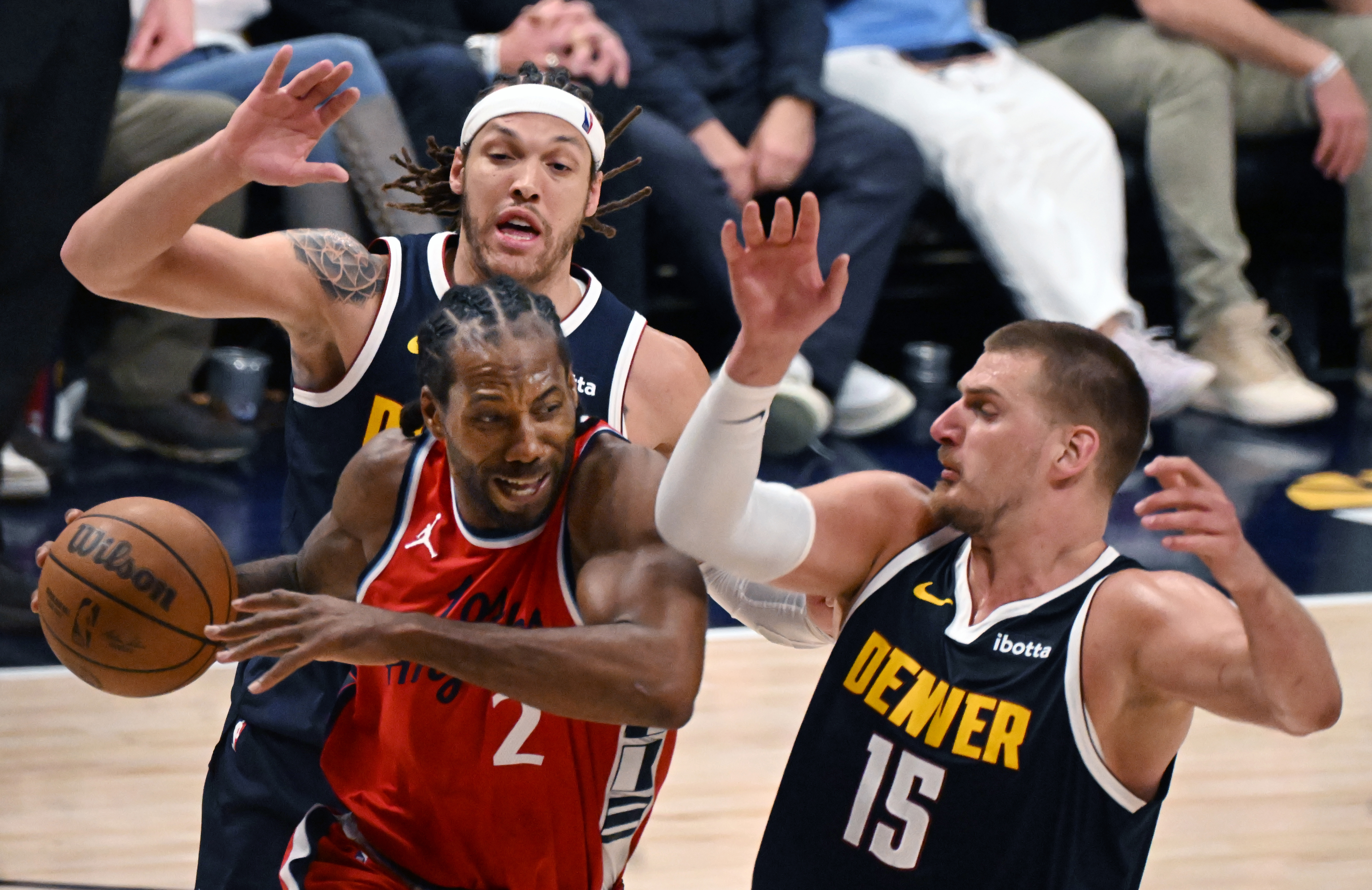 Denver Nuggets center Nikola Jokic (15) and Denver Nuggets forward Aaron Gordon (32) defend LA Clippers forward Kawhi Leonard (2) during the 4th quarter of game 2 of Round 1 of the NBA Western Championship at Ball Arena on Monday, April 21, 2025. (Jerilee Bennett,The Gazette)