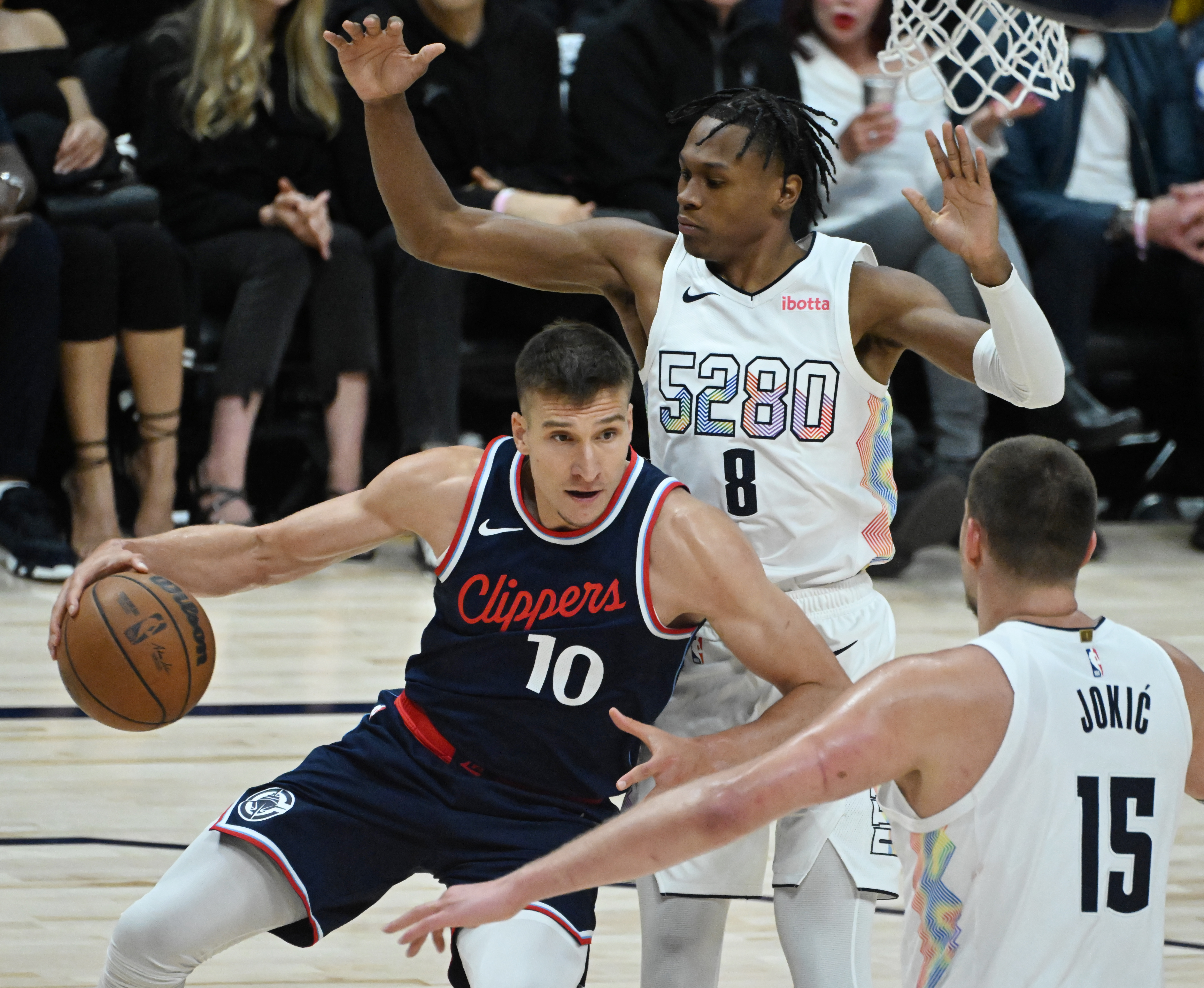 LA Clippers guard Bogdan Bogdanovic (10) is pressured by Denver Nuggets forward Peyton Watson (8) and Denver Nuggets center Nikola Jokic (15) causing him to travel during the 3rd quarter of game 5 of the first round of the Western Championships at Ball Arena on Tuesday, April 29, 2025. (Jerilee Bennett,The Gazette)