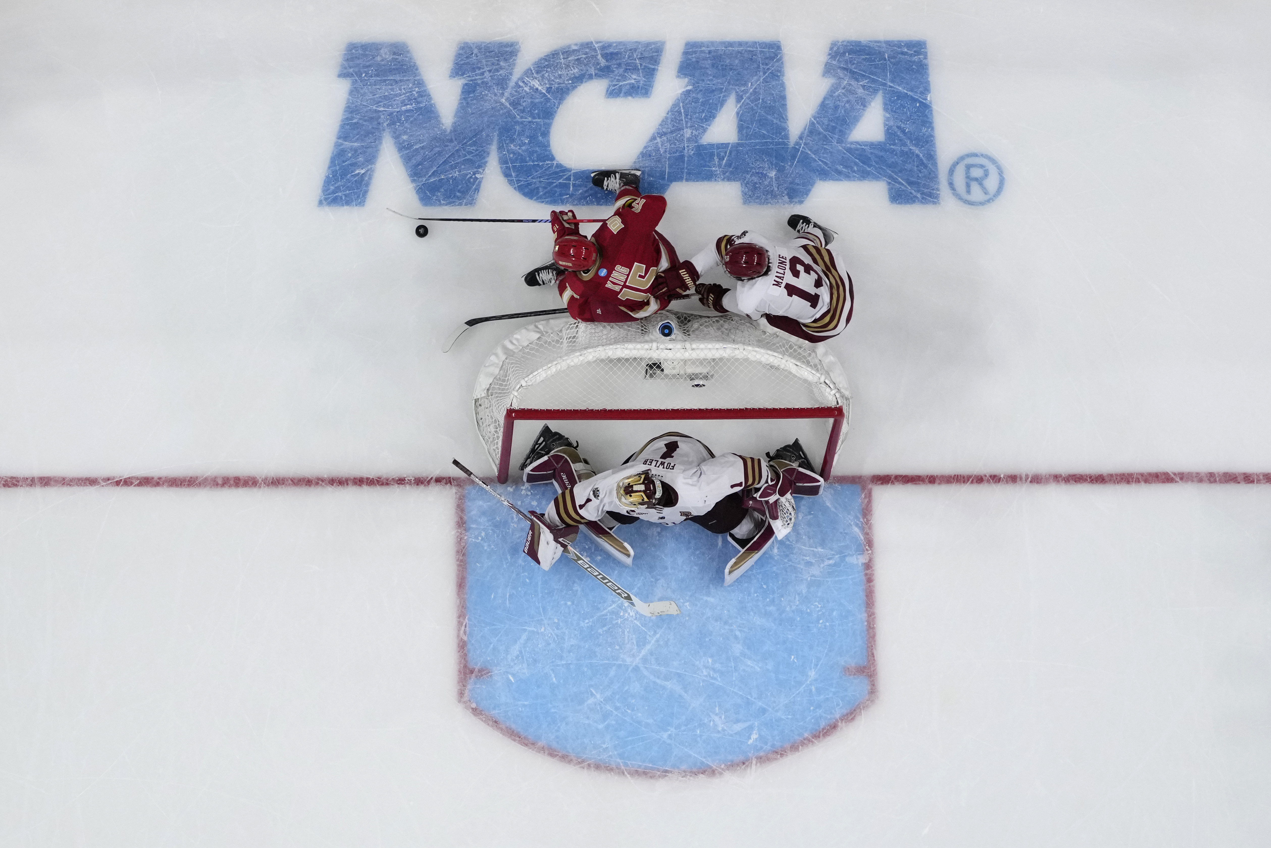 Denver forward Carter King (15) skates with the puck as Boston College forward Jack Malon (13) dedends uring the third period in the Frozen Four championship game of the men's NCAA college hockey tournament Saturday, April 13, 2024, in St. Paul, Minn. (AP Photo/Abbie Parr) (Abbie Parr)