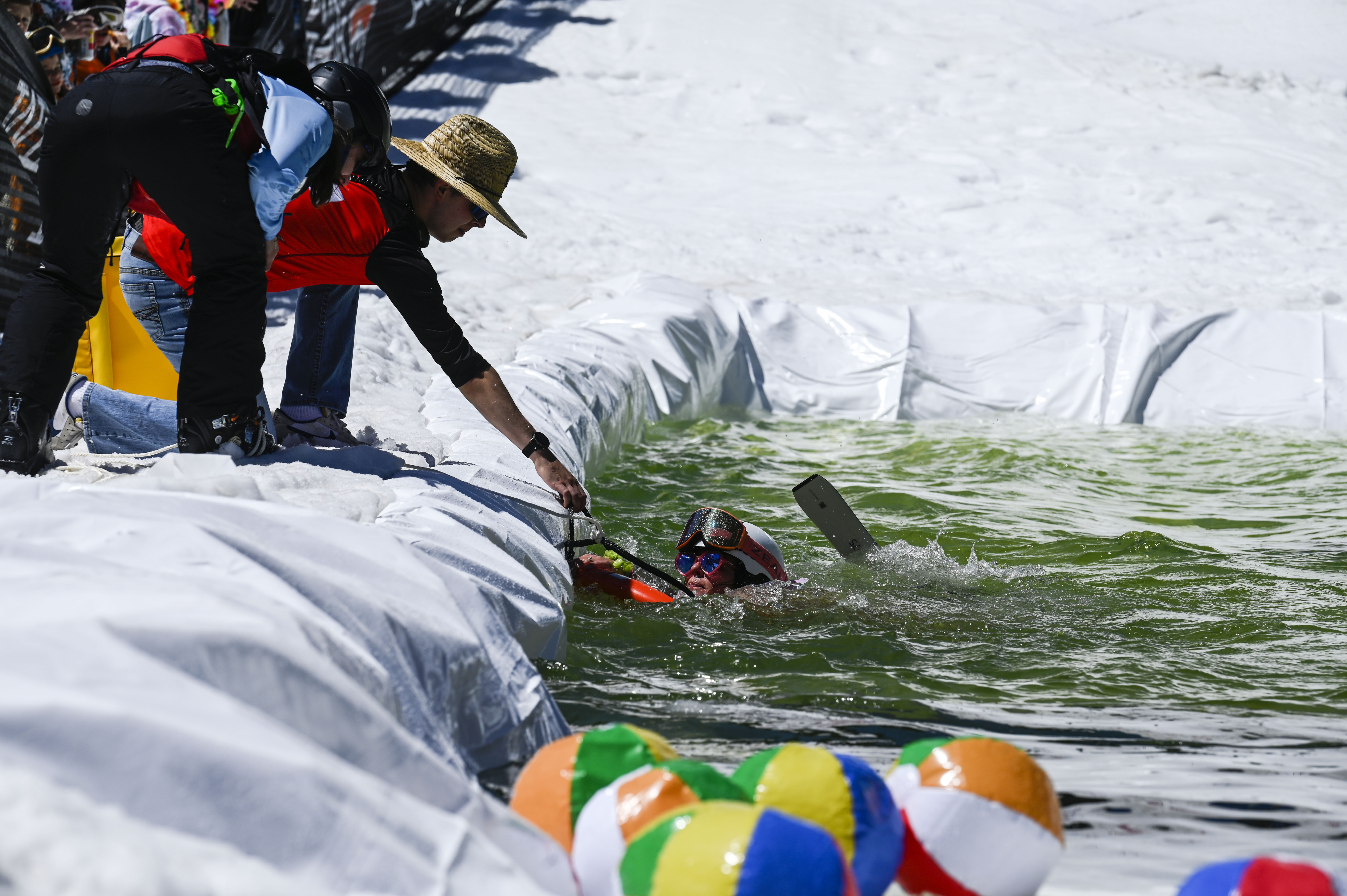 Members of the ski patrol help a competitor out of the water after she fell in at the base of Winter Park during the Spring Splash event to celebrate the last day of the season on Sunday, April 27, 2025 (Stephen Swofford, Denver Gazette) (StephenSwoffordPhotographerstephen.swofford@gazette.comhttps://secure.gravatar.com/avatar/1ddcaf11c5d70eaa58546ddc4e038687?d=mm&r=g)