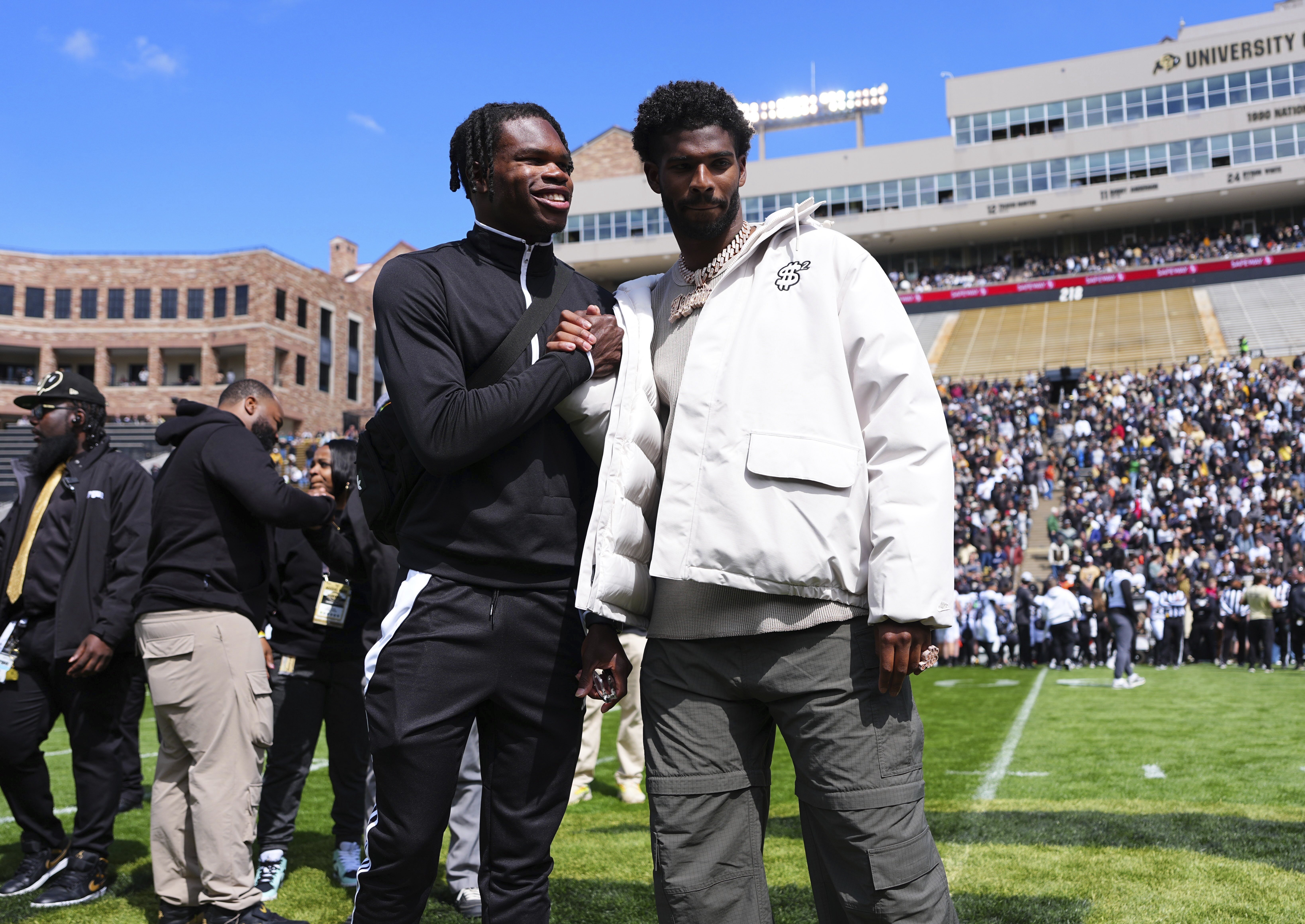 Travis Hunter, left, and Shedeur Sanders, right, react to their jersey retirements during Colorado's spring game on Saturday in Boulder. (The Associated Press)